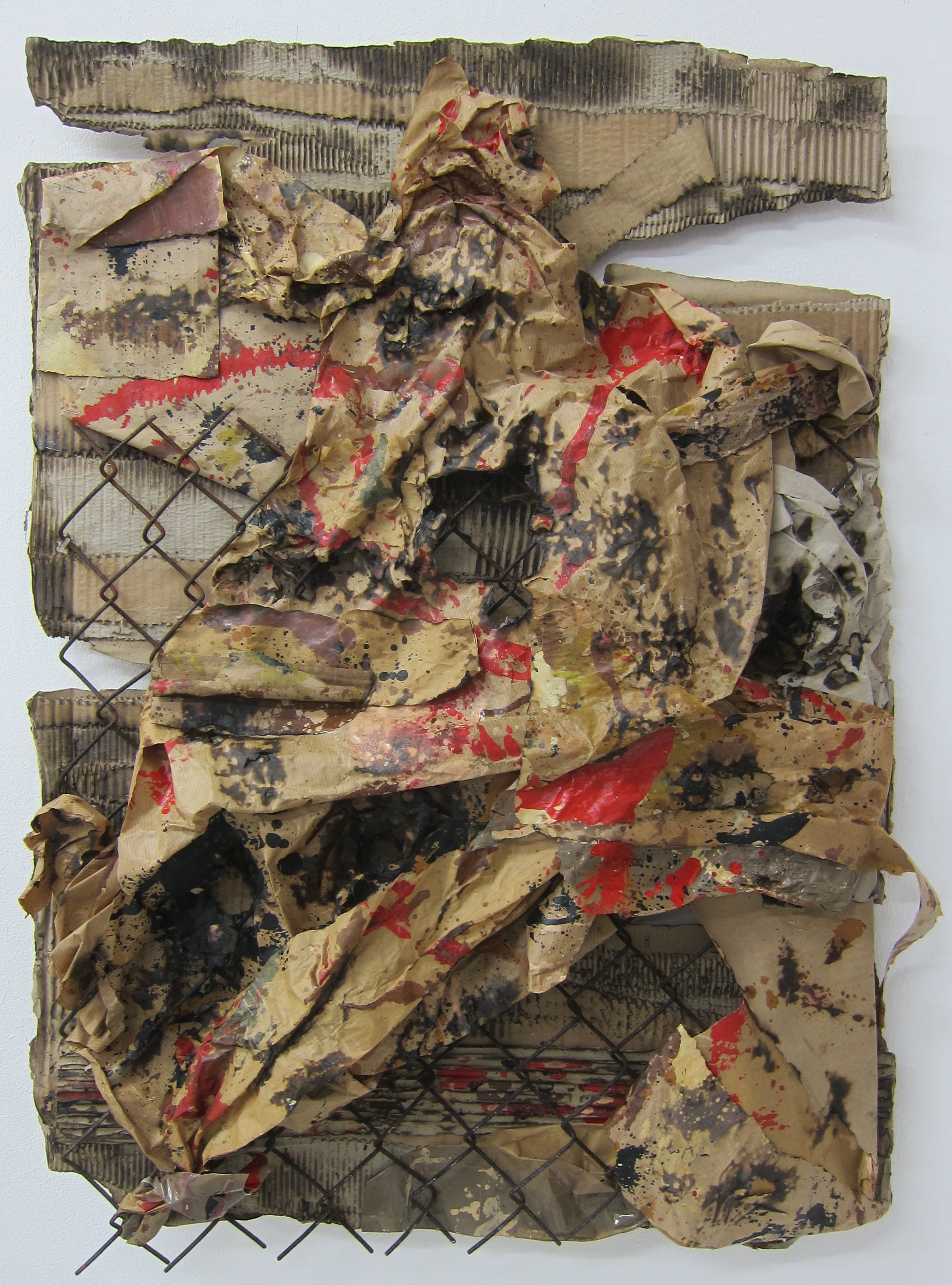   Womble Burner.   Cardboard, paper,&nbsp;alkyd resin, fence, fire and water.&nbsp;  80 x 58 cm.  2015.&nbsp; 