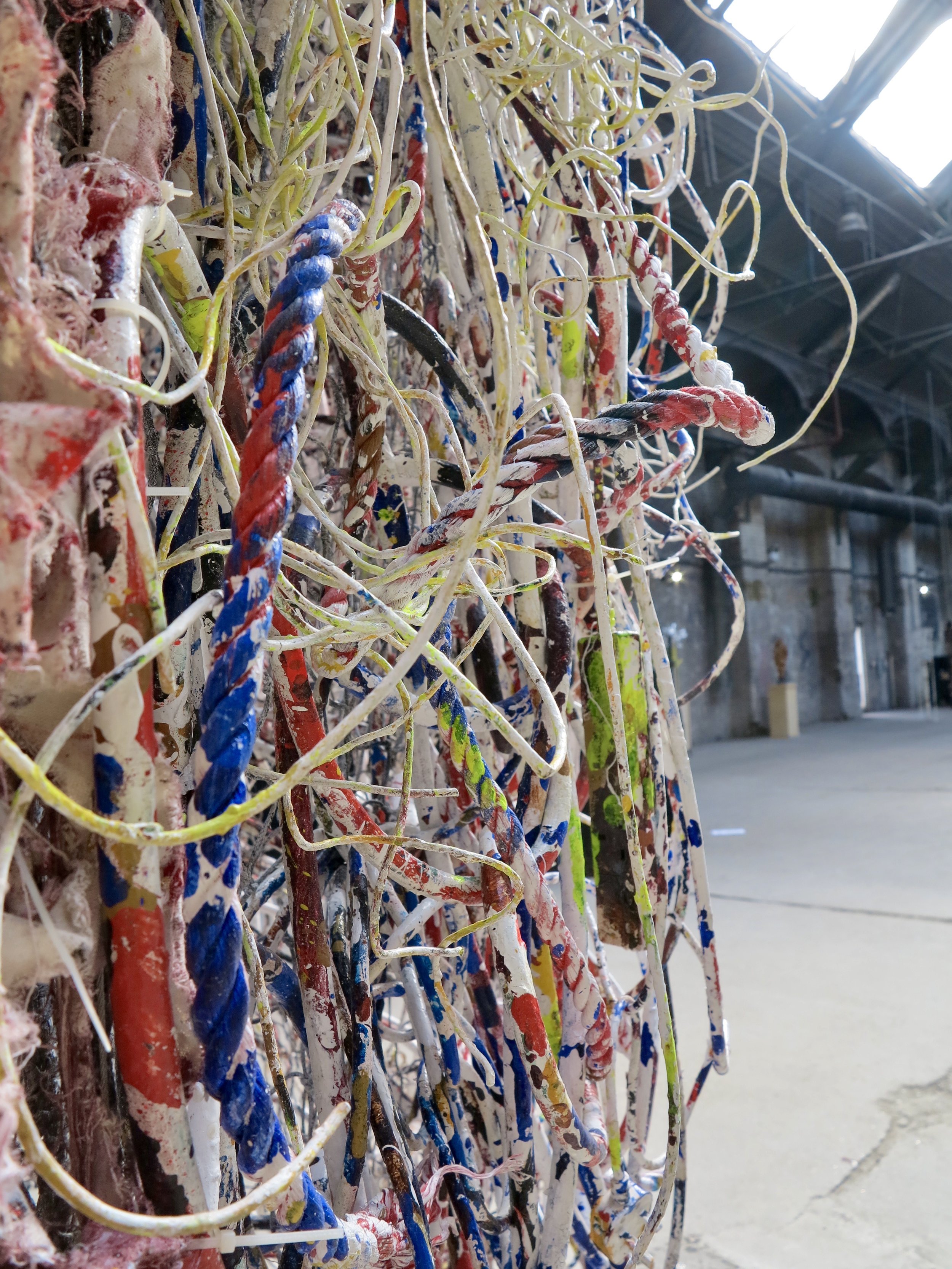    Detail from  Hung Out to Dry    Gleaned electrical wires, ropes, and hand-torn ‘tagliatelle’ woven into industrial netting and hung with polymer-lichen canvas and printed debris nets  Part of the  Pigeon Park 2   exhibition, London 2022 