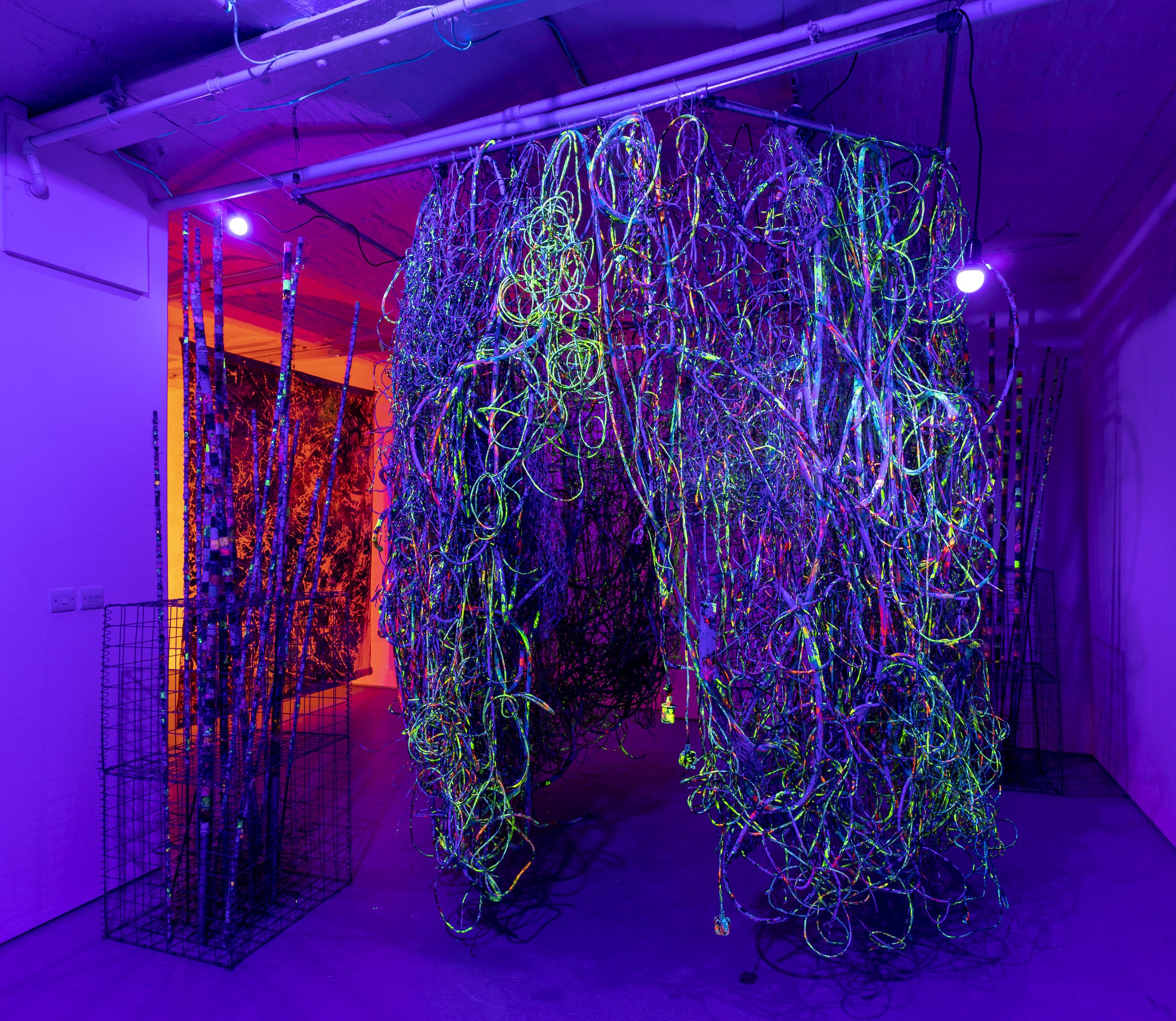   Children of the Rave   Gleaned electrical wires, ropes and PVC tubes weaved into polyethylene nets and steel fencing, with UV installation  270 x 230 x 230cm  Part of the  Ghost Notes  duo presentation with Carolina Aguirre, at Fold Gallery, London