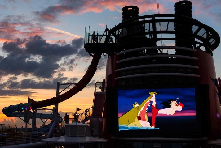 All Disney Everything - You can watch Disney films on the large-scale “Funnel Vision” screen at the Goofy Pool or Donald Pool during the day or night. Disney ships even play Disney, Star Wars and Marvel films the same day they’re released in theaters, broadcasting the newest films inside the Buena Vista movie theater.