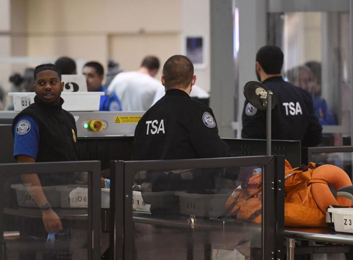 Transportation Security Administration officers (TSA) stand screen passengers at the departure area of the Los Angeles International Airport in Los Angeles, California, on 5 January, 2019. – TSA staff are taking sick leave in record numbers since the partial government shutdown forced them to work without pay from December 22, 2018. (Photo by Mark RALSTON / AFP) GETTY