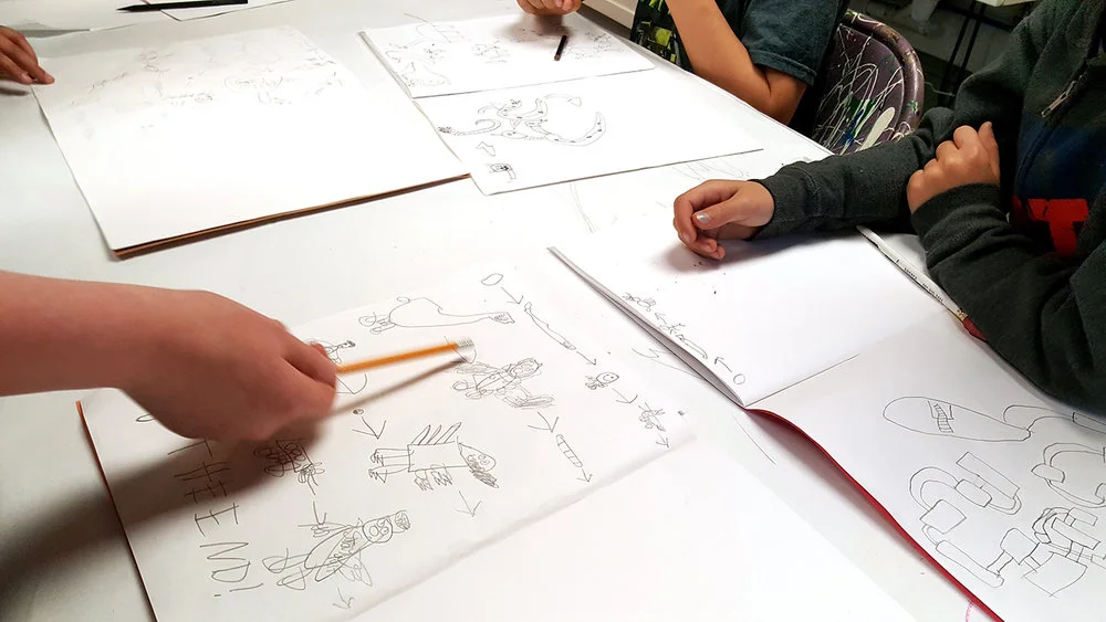 Students playing a favorite drawing game borrowed from the Providence Comics Consortium workbook, "Food Chain!"