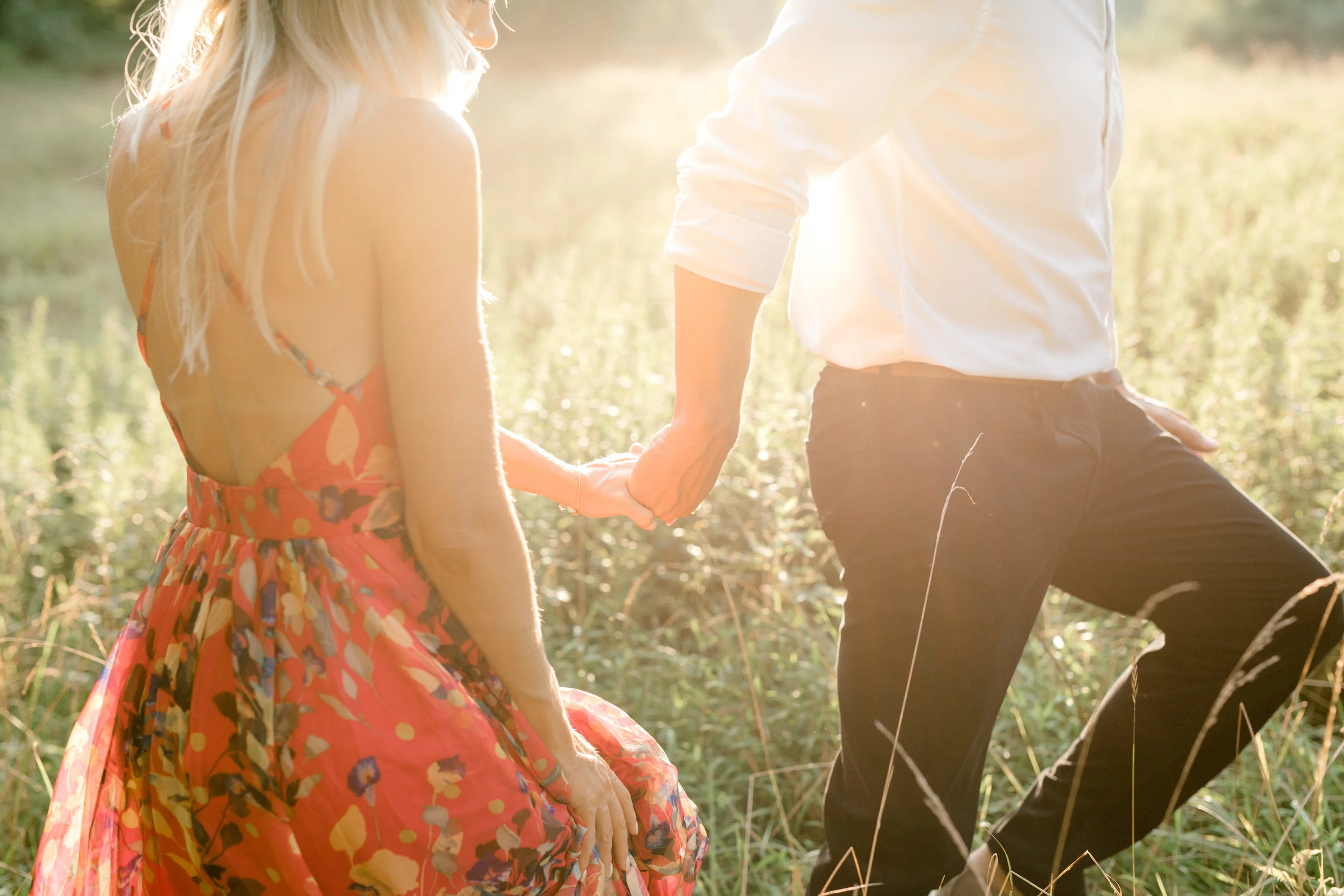 In this romantic sunset woodland engagement session at Parque at Ridley Creek, Bill leads Liz into a glowing sunlit field hand-in-hand. An intimate moment that feels a little boho, we love it.
