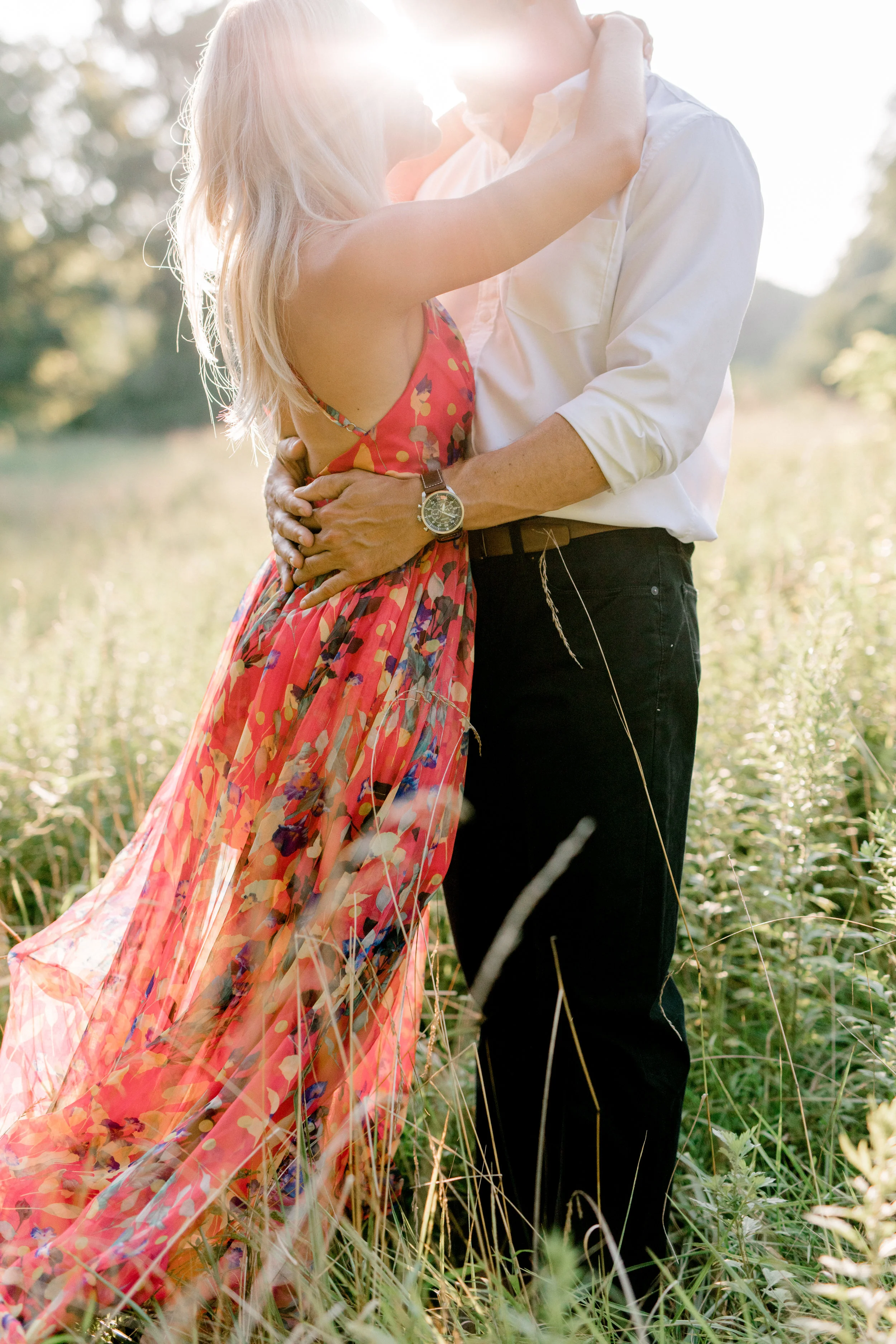 Liz and Bill holding onto each other in an intimate moment for their romantic sunset woodland engagement session at Parque at Ridley Creek.