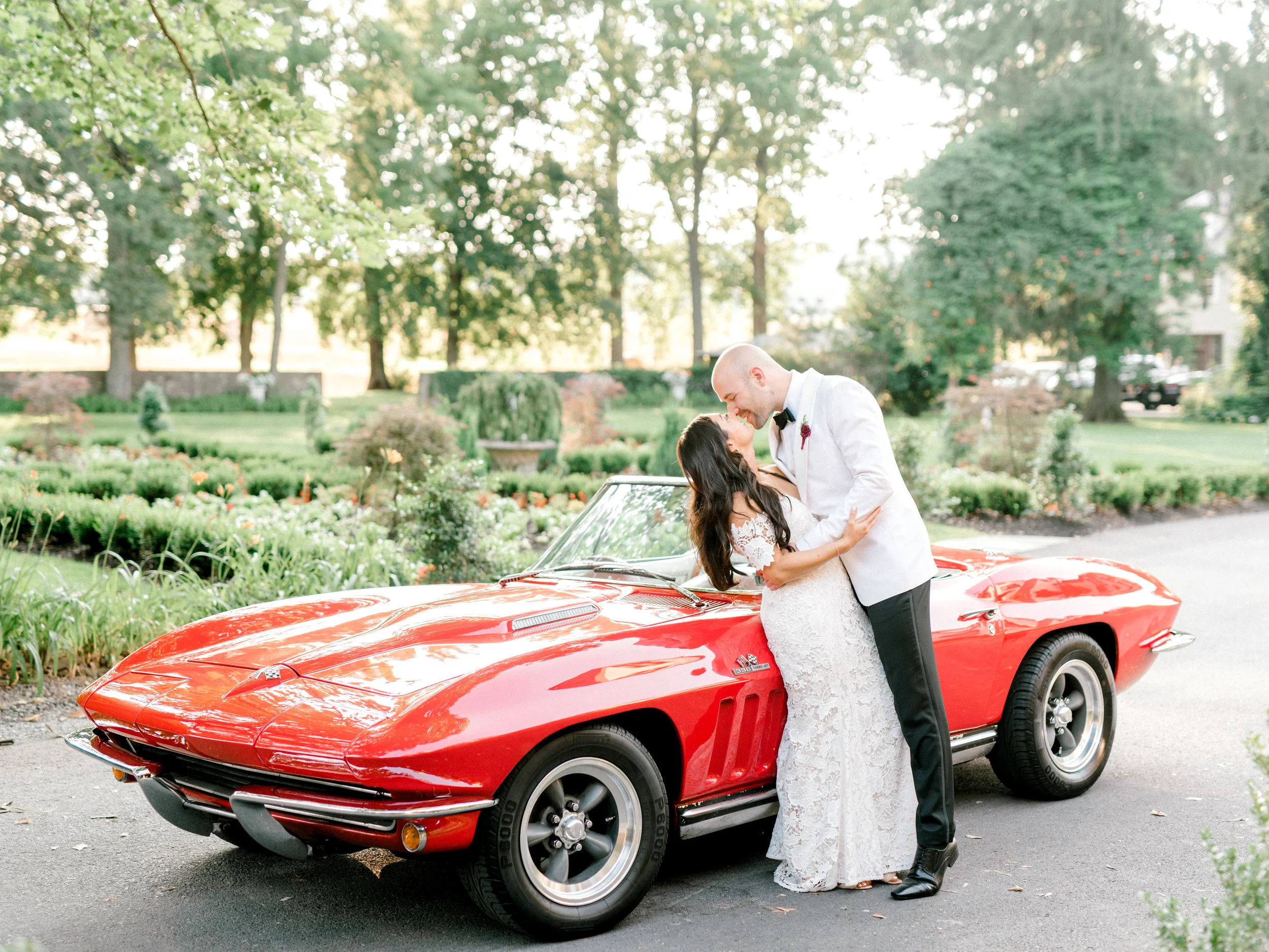 Colorful and modern summer wedding at Hotel du Village. Red sports car portrait.