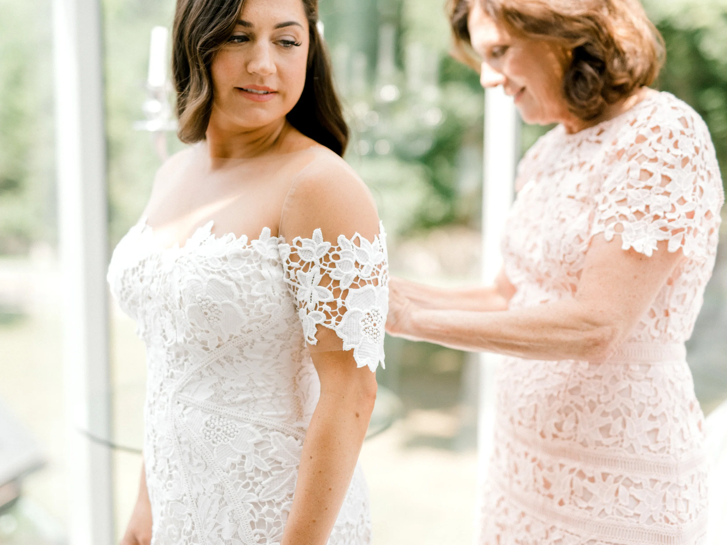Lindsey’s mom helps her get into her Lover’s Society dress in this light filled AirBnb before her colorful and modern wedding day at Hotel du Village.
