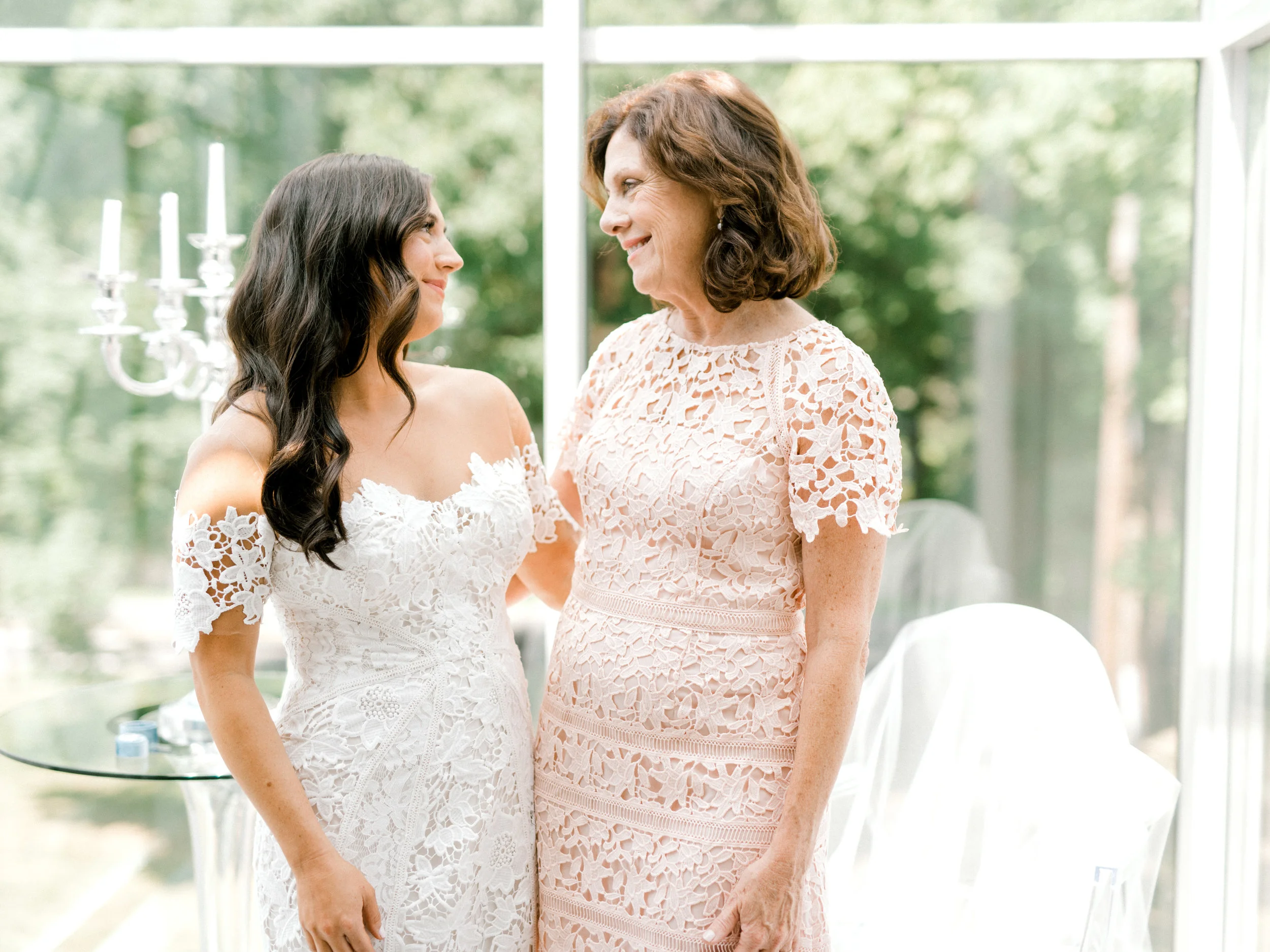 Lindsey and her mom share a moment in this light filled AirBnb before her colorful and modern wedding day at Hotel du Village.