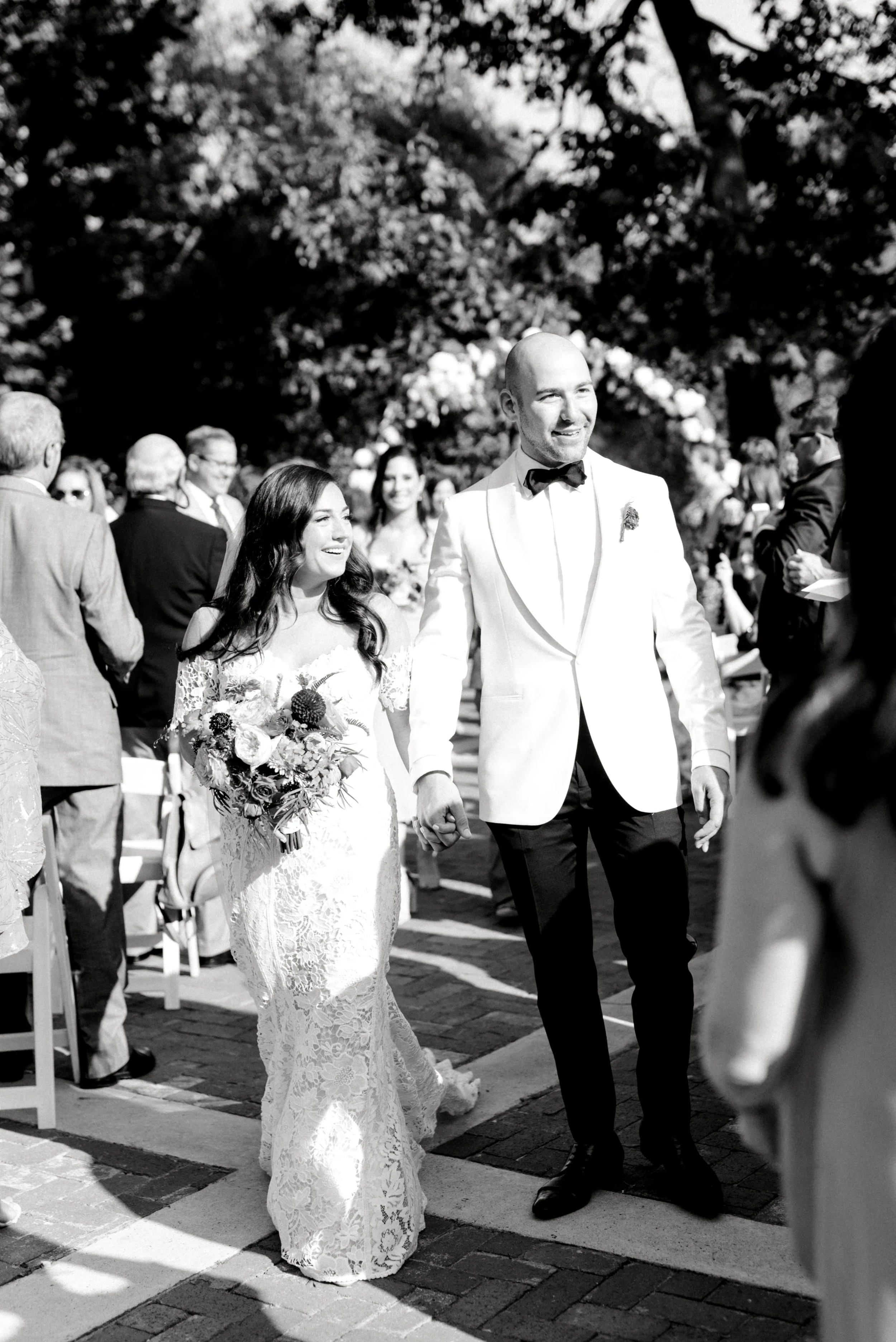 Happily married, these two recess back down the aisle after saying their vows for their bright summer wedding at Hotel du Village.