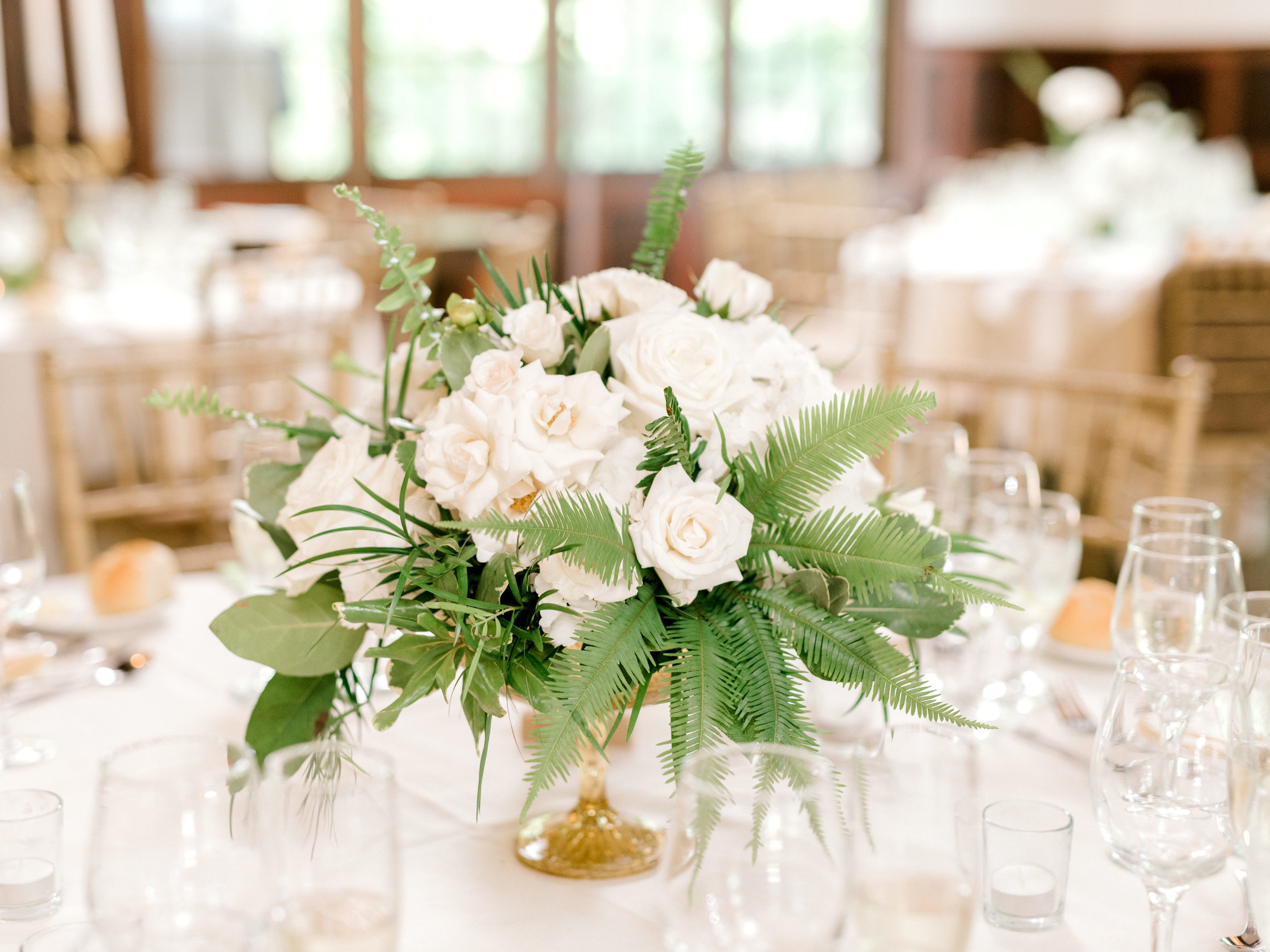 We loved the modern mix of white roses and green ferns to add a bright pop to this elegant and modern summer wedding at Hotel du Village.