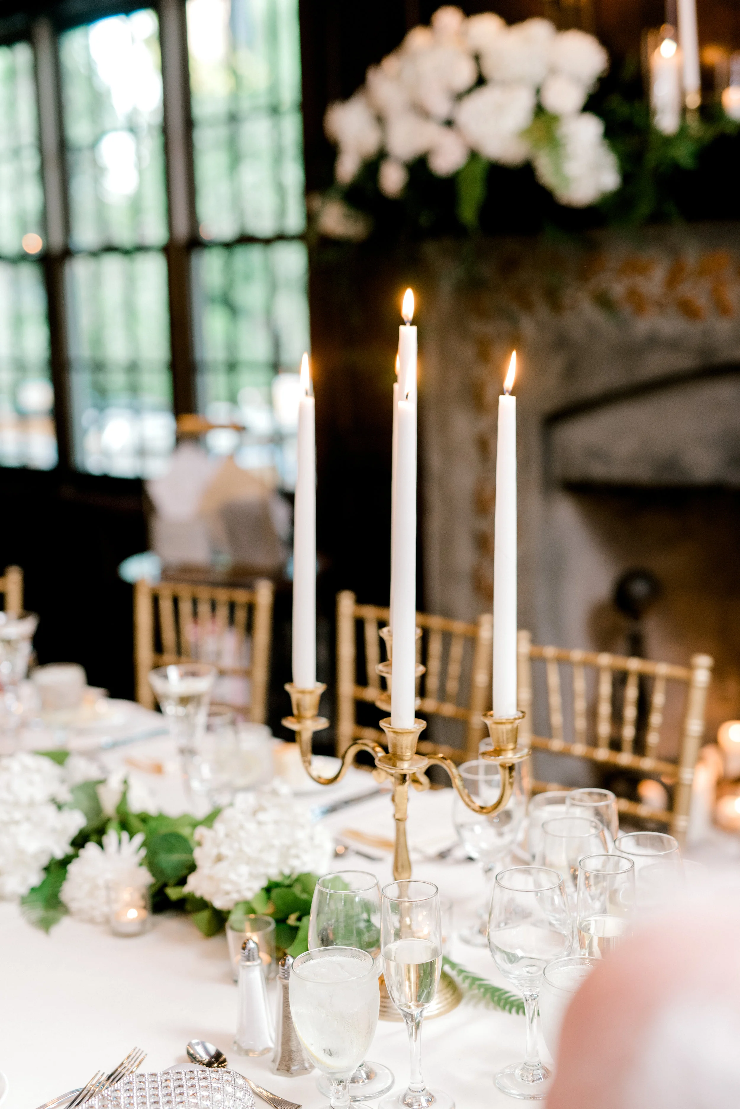 Gold candelabras with white taper candles add a touch of opulence and elegance to this bright and modern summer wedding at Hotel du Village.