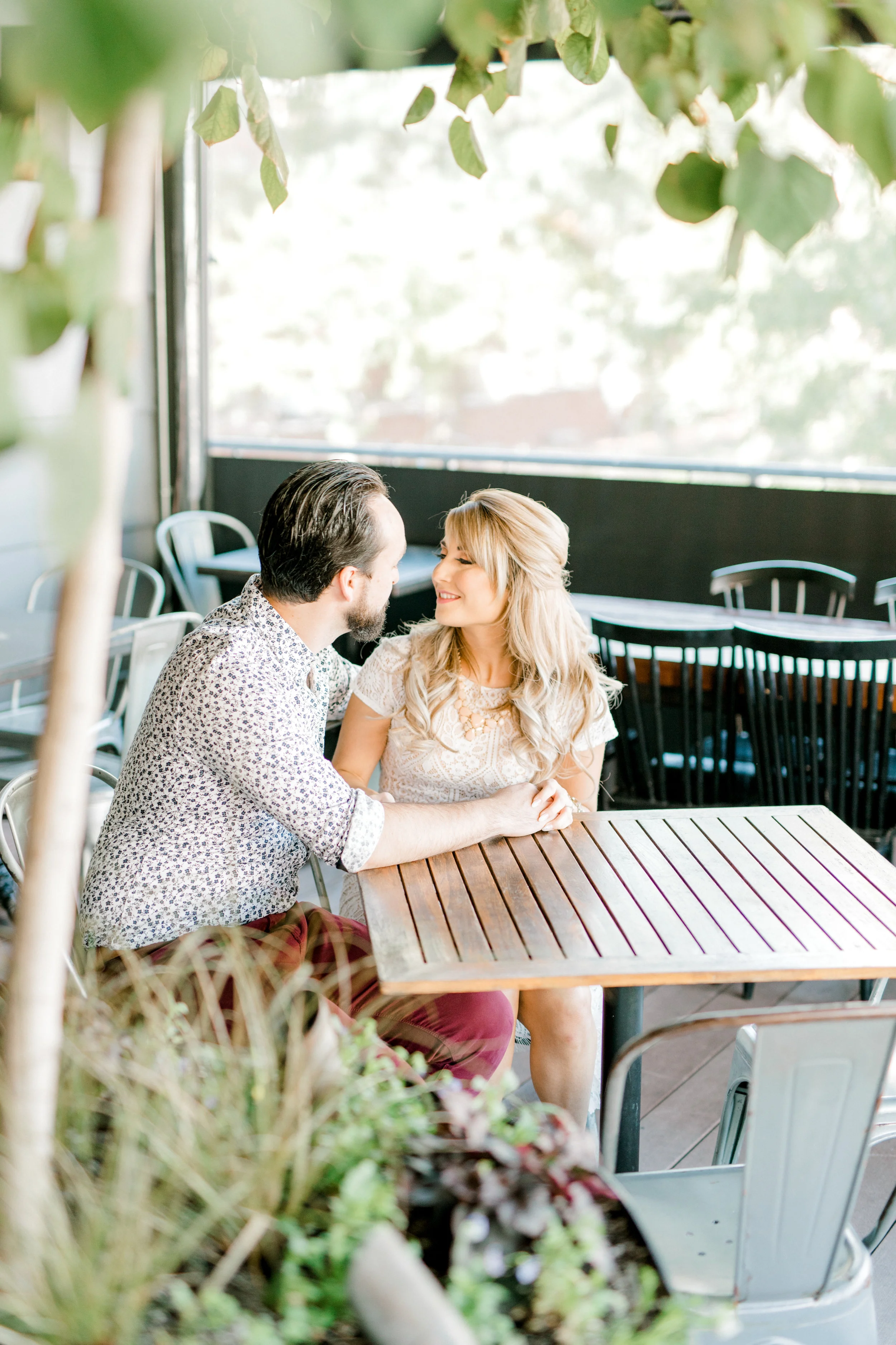 Nikki and Dale sitting on the roof deck for their romantic fall engagement session at the Revolution House in Old City, Philadelphia.