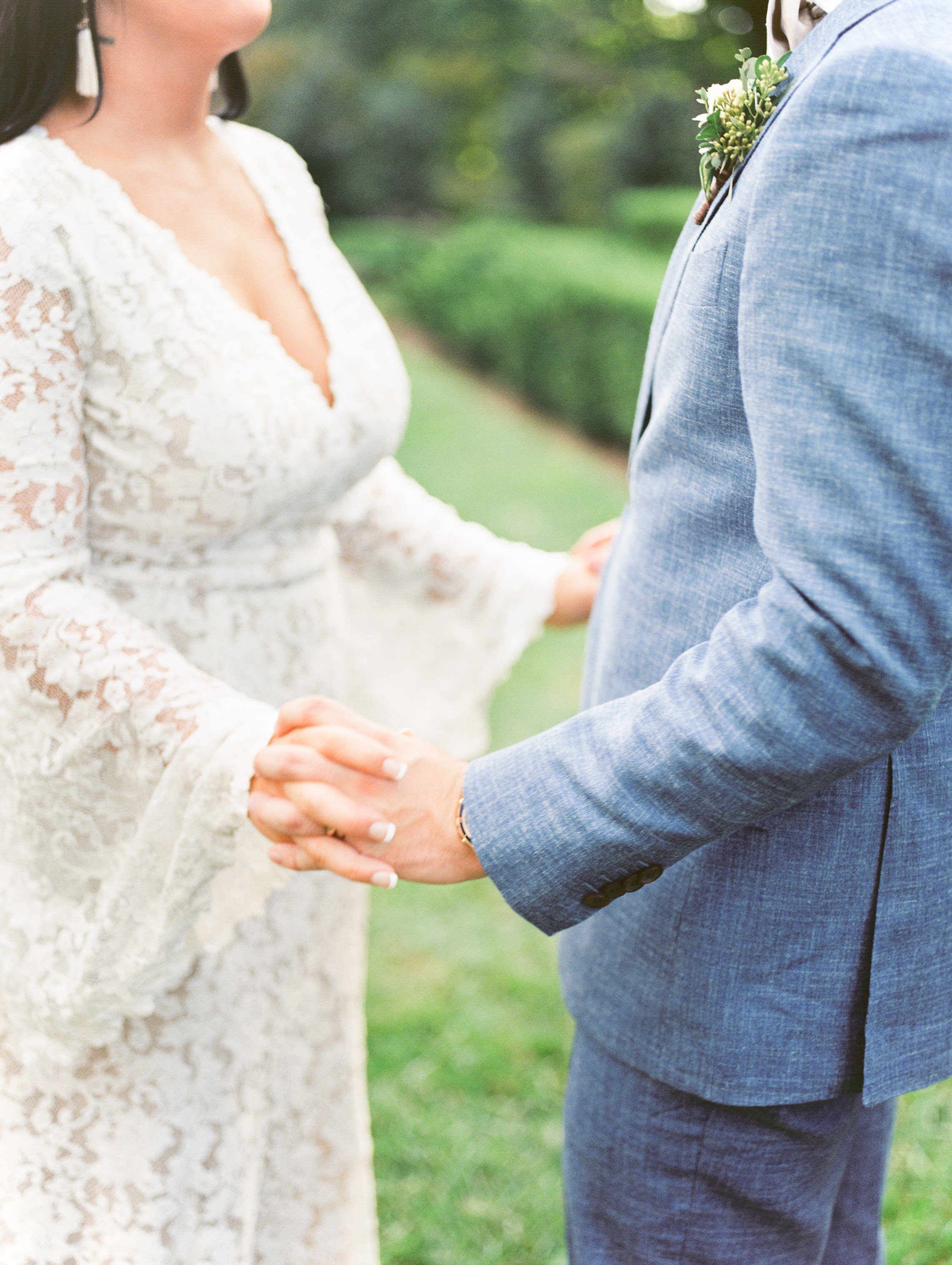 A sweet moment holding hands at this bright boho chic Tyler Gardens wedding in Bucks County, and we still can’t get over this BHLDN gown or that light blue suit.