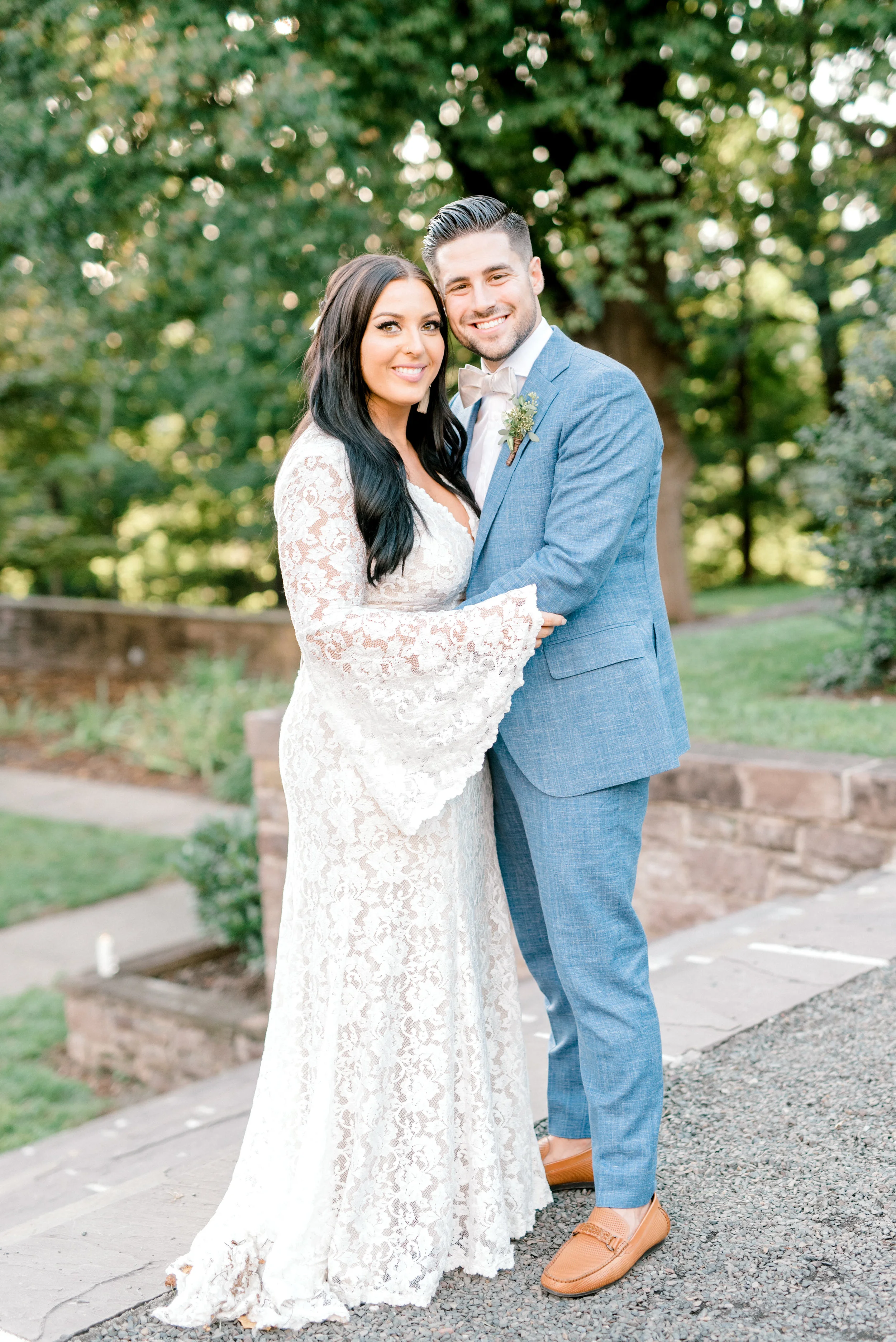 We got all the hippy vibes from this bell sleeved BHLDN gown paired with this light blue suit from this bright boho chic Tyler Gardens wedding in Bucks County
