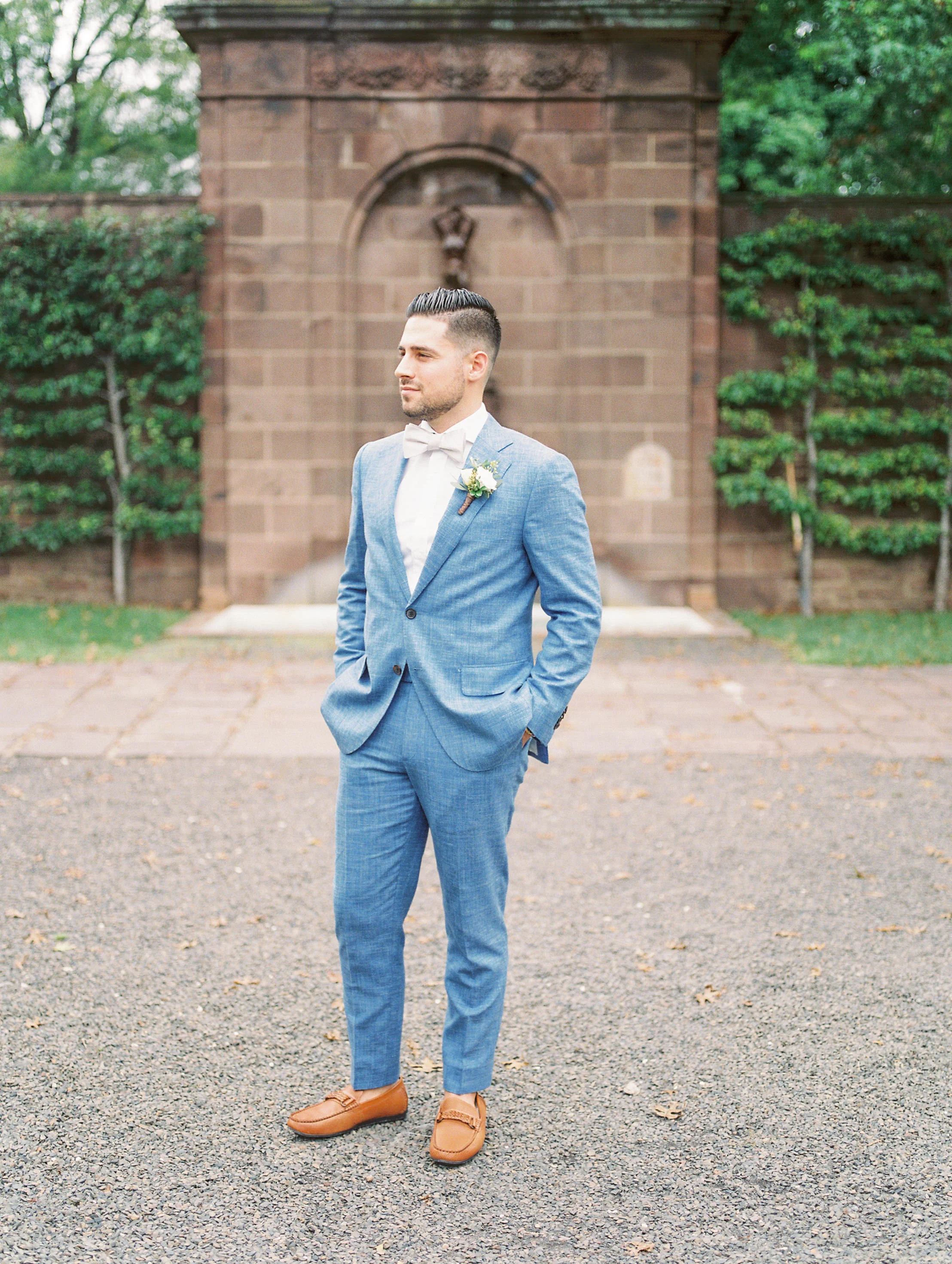 This groom’s light blue suit paired with brown leather loafers and white bowtie made him one stylish and timeless looking man for his bright boho chic Tyler Gardens wedding in Bucks County