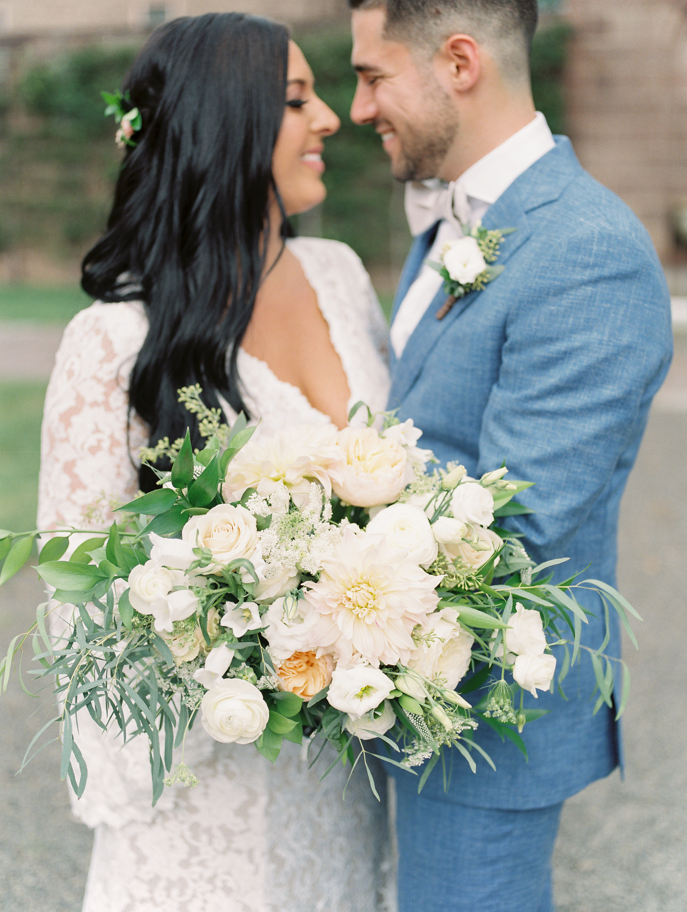 A totally gorgeous wild white, blush, and green bouquet by Maura Rose Events from this bright boho chic Tyler Gardens wedding in Bucks County, plus we dig this light blue suit