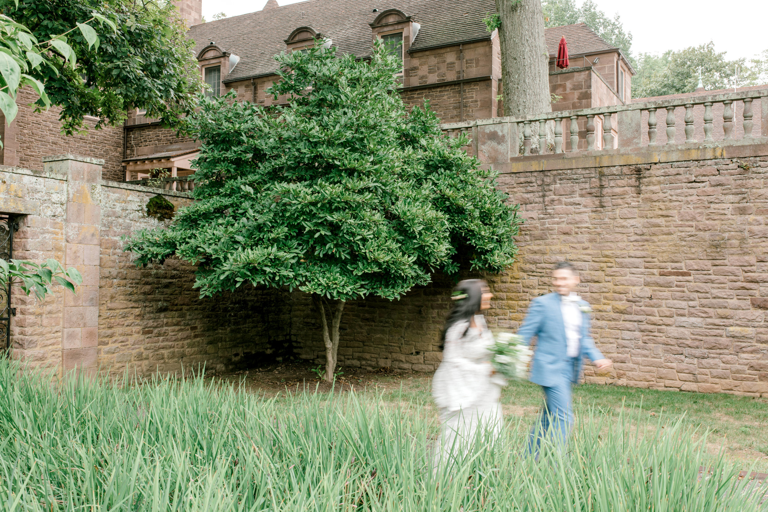 Running together through the garden, these two made a romantic moment happen at their bright boho chic Tyler Gardens wedding in Bucks County