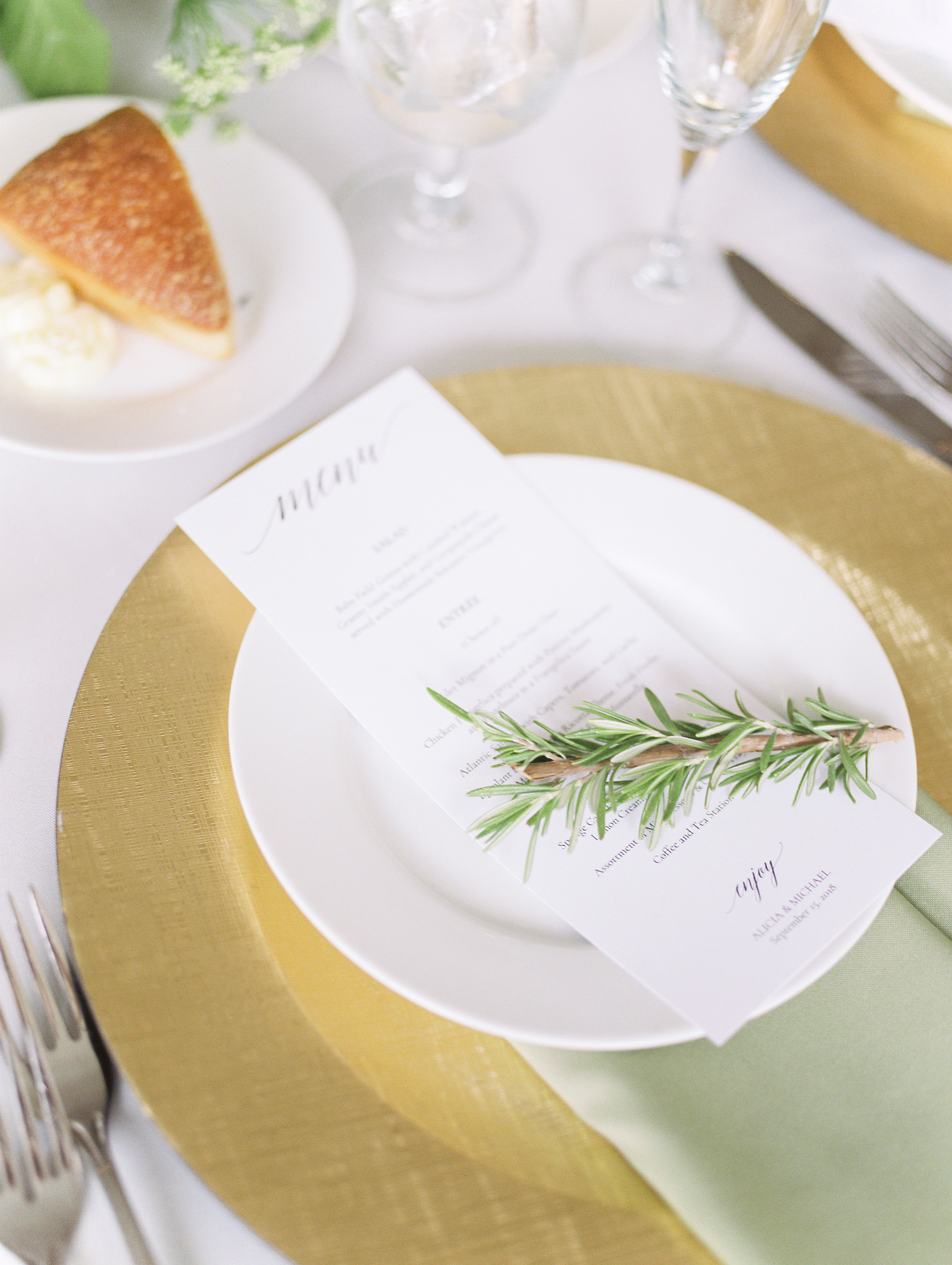 Beautiful and minimal menus topped with a sprig of Rosemary bring all the European vibes to this white and gold place setting at this bright boho chic Tyler Gardens wedding in Bucks County