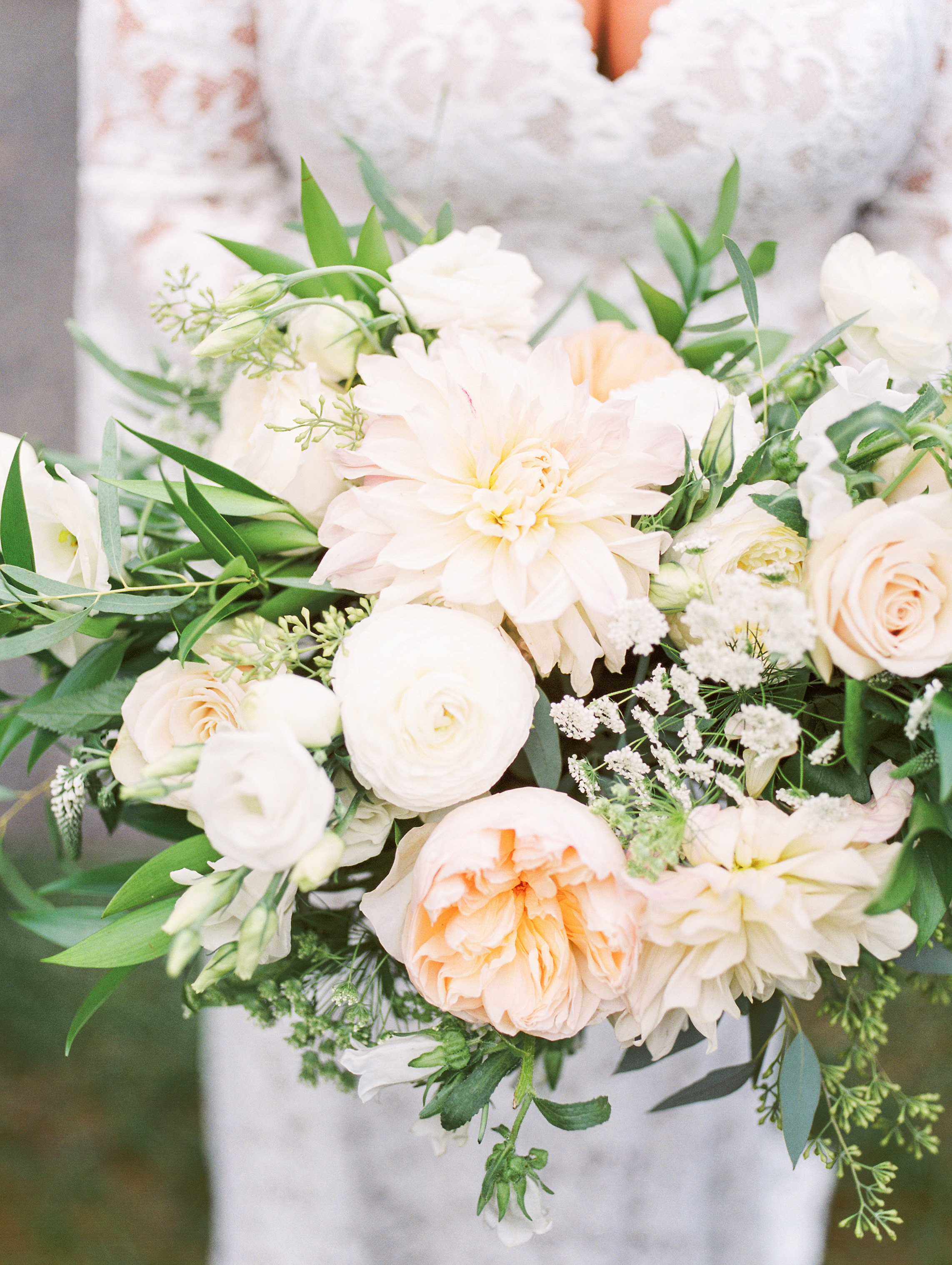 A close up of these grogeous light flowers in shades of white and blush with plenty of greenery from this bright boho chic Tyler Gardens wedding in Bucks County