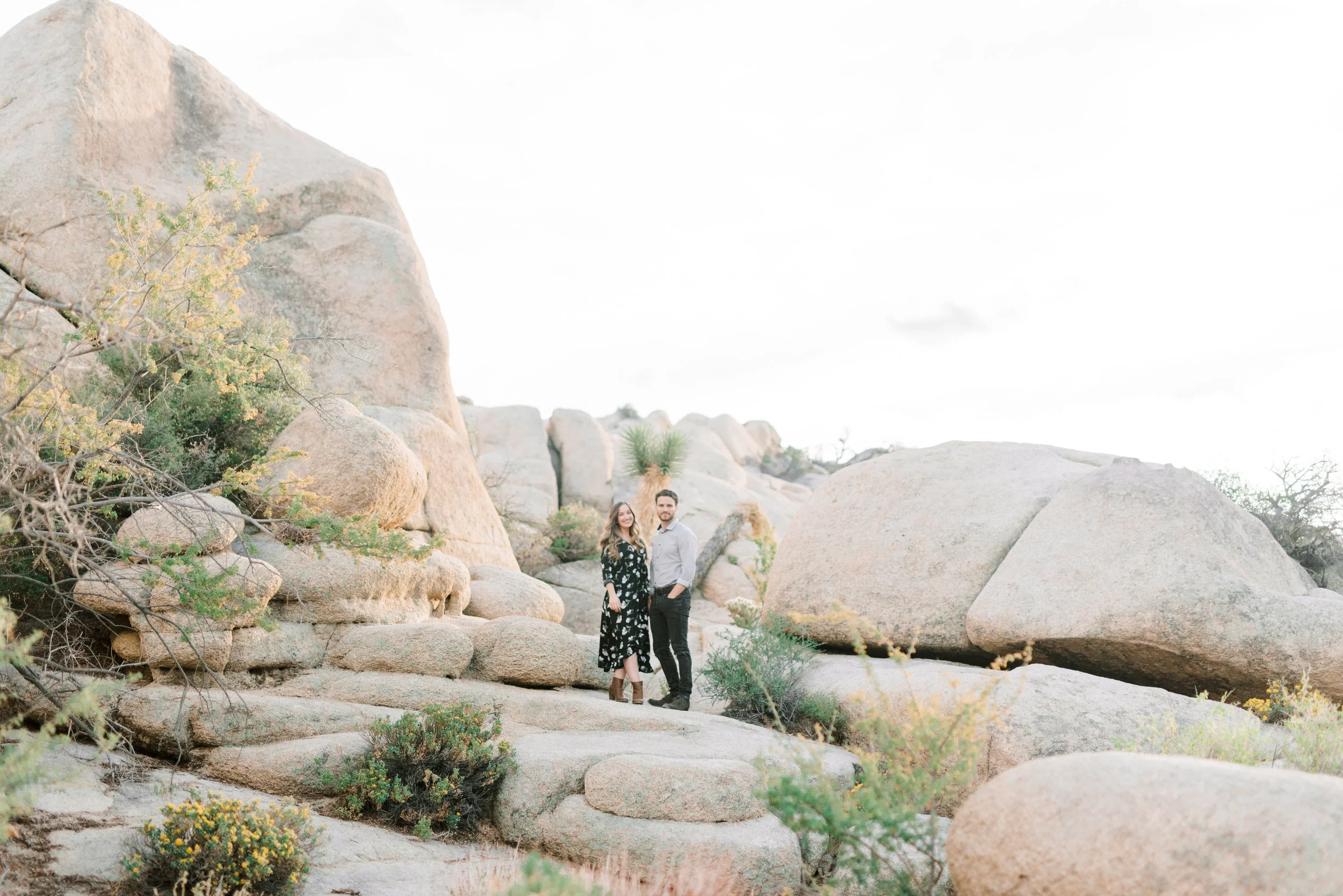 The rocky landscape in the sunset made for a dramatic backdrop at this free-spirited desert engagement session in Joshue Tree