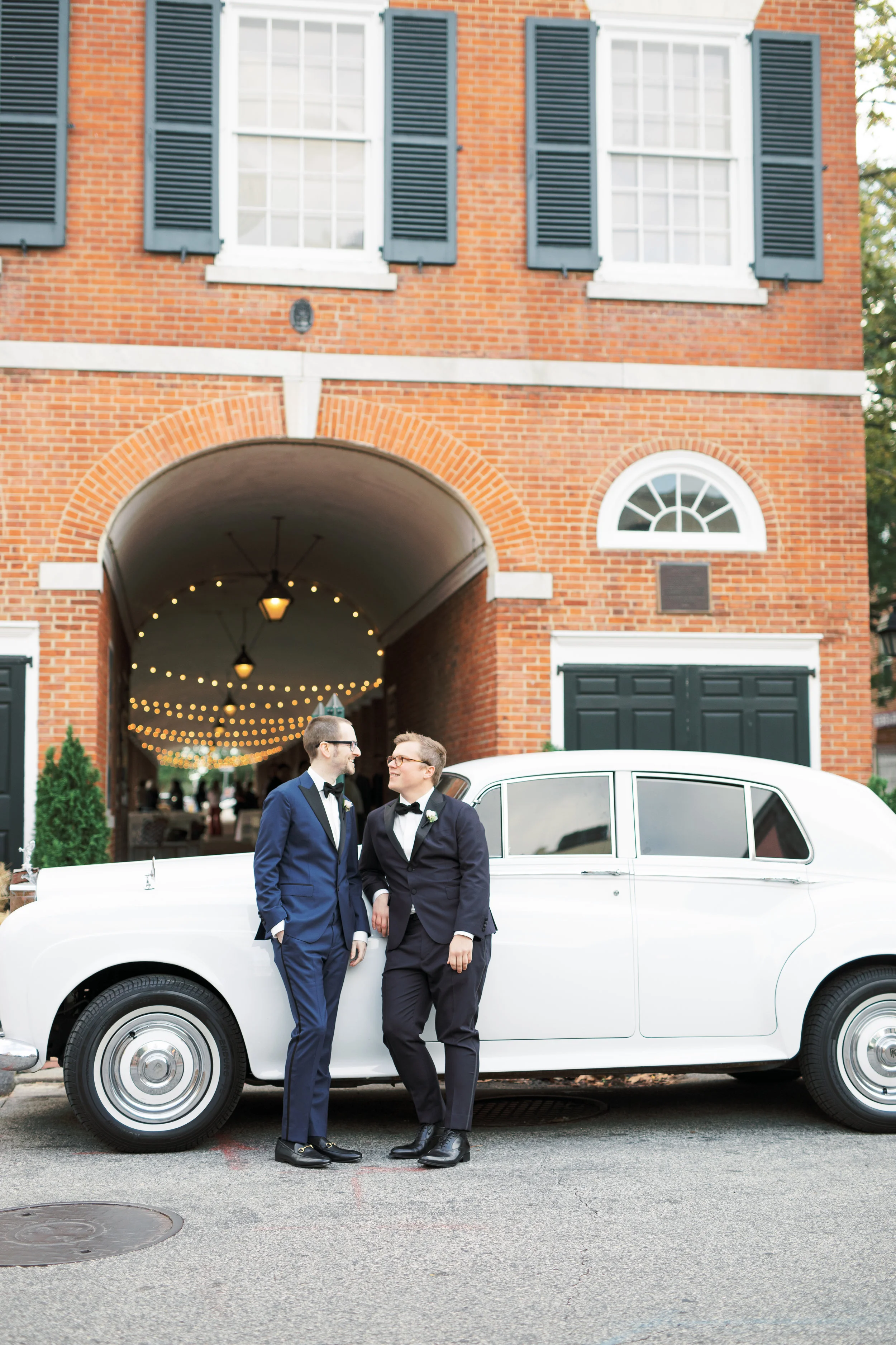 same sex wedding, two grooms with glasses on their Philadelphia wedding day with a Rolls Royce in classic Headhouse Square