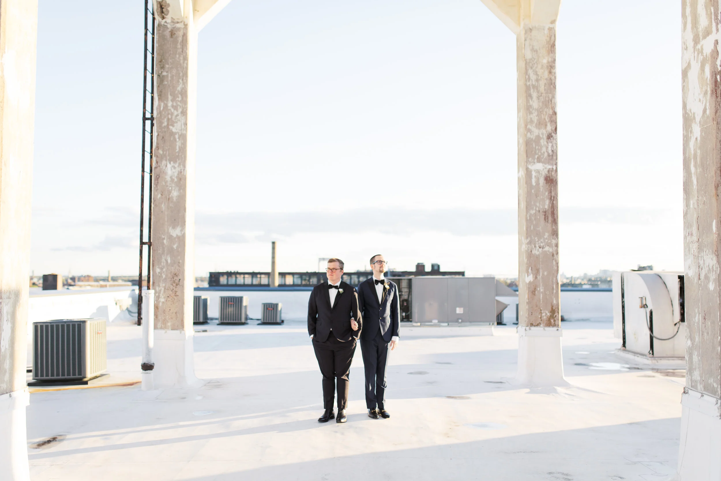 same sex wedding on a industrial and modern rooftop at FAME in Philadelphia with skyline view