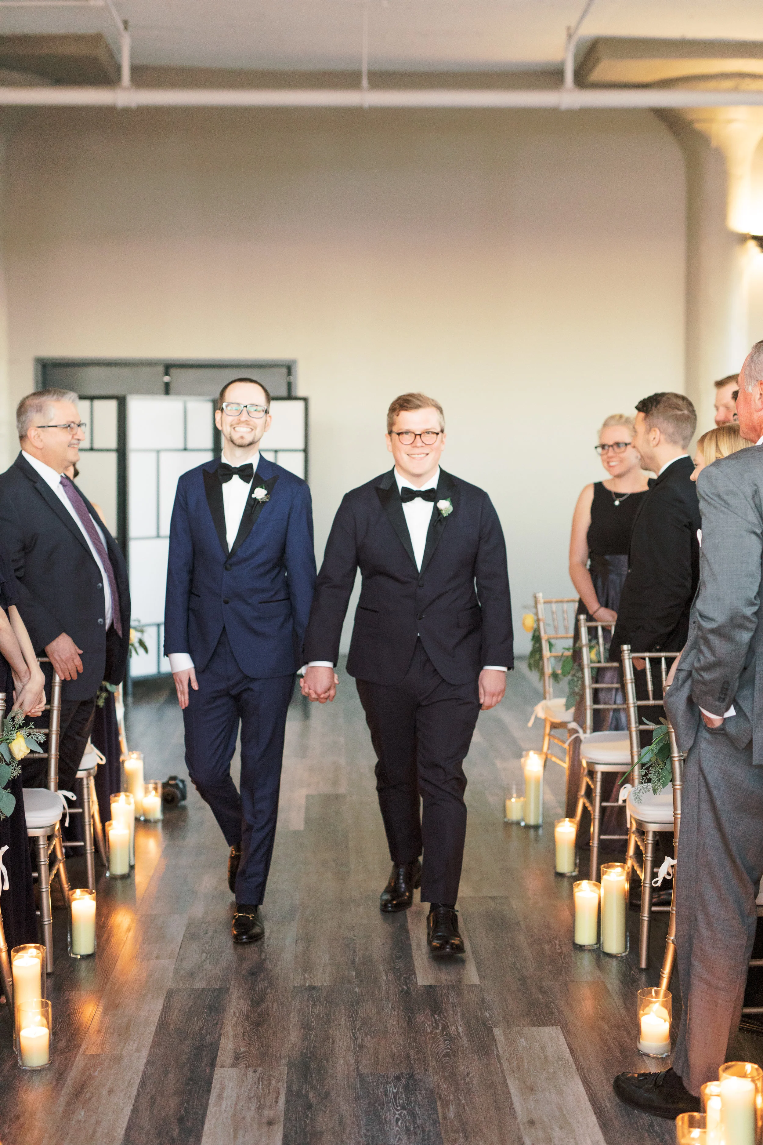 two grooms walking down the aisle together at FAME, industrial and modern Philadelphia venue