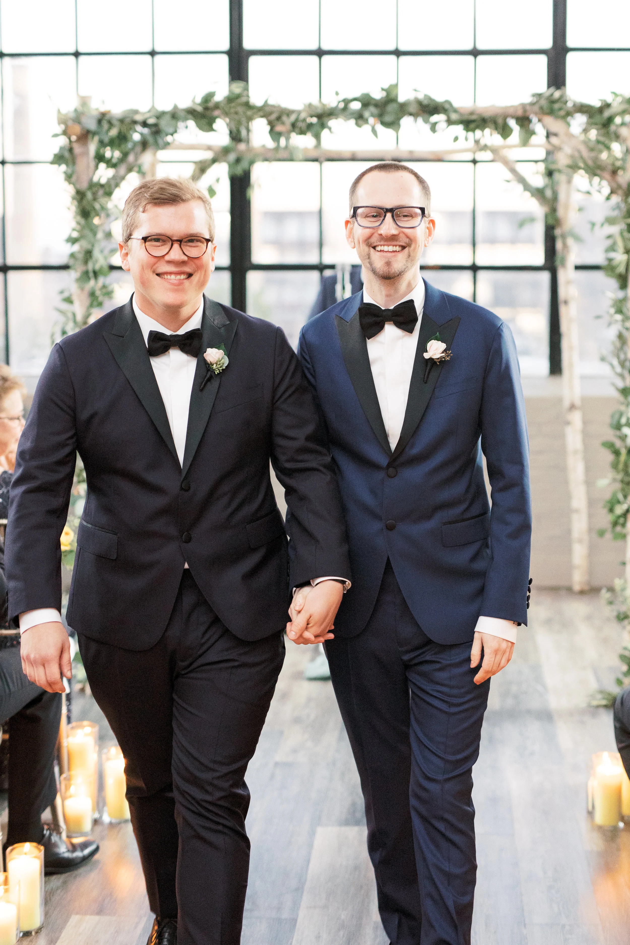 same sex wedding ceremony at FAME, industrial and modern warehouse Philadelphia wedding venue, precessing as husbands