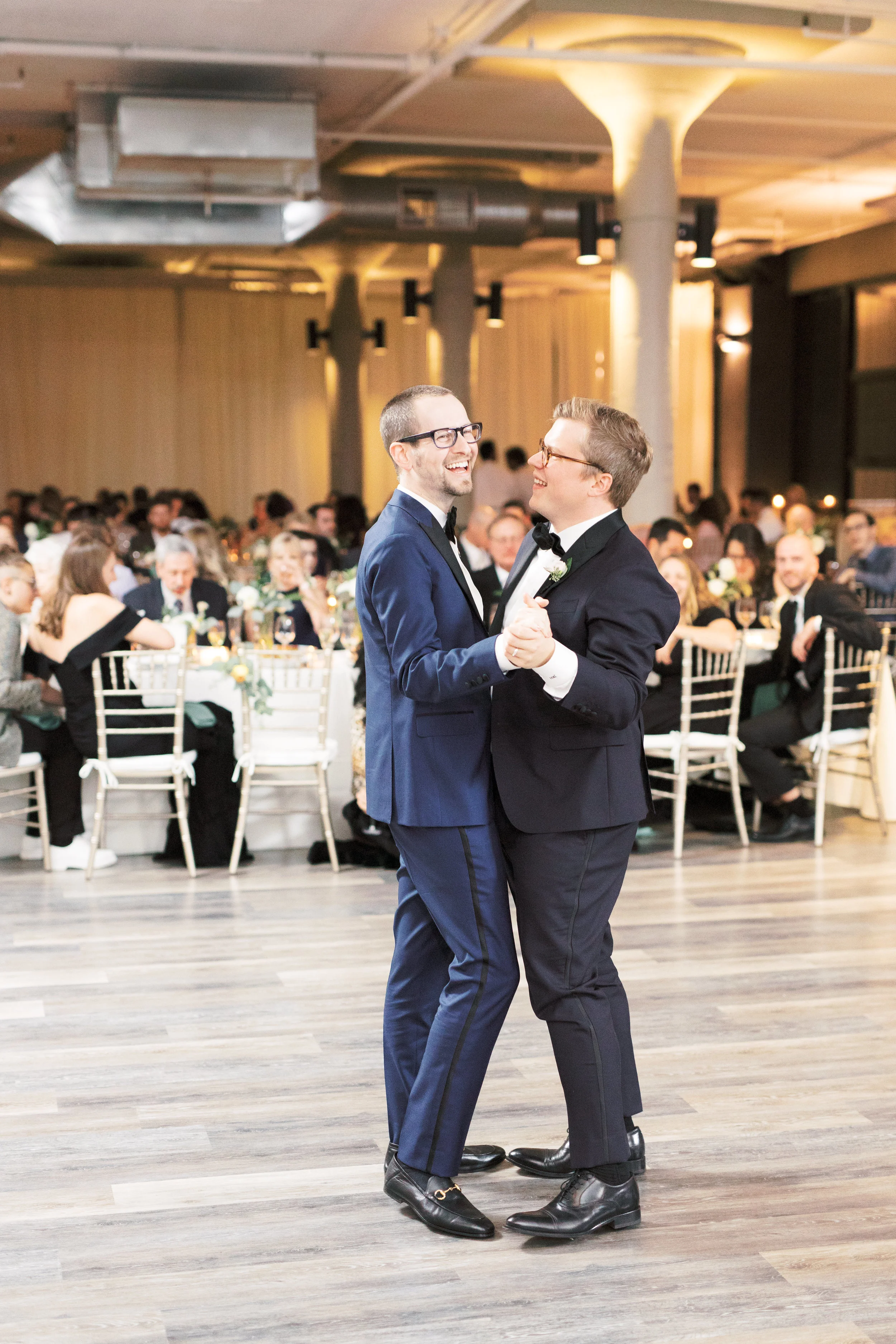 two grooms sharing their first dance as husbands at FAME, Philadelphia wedding venue