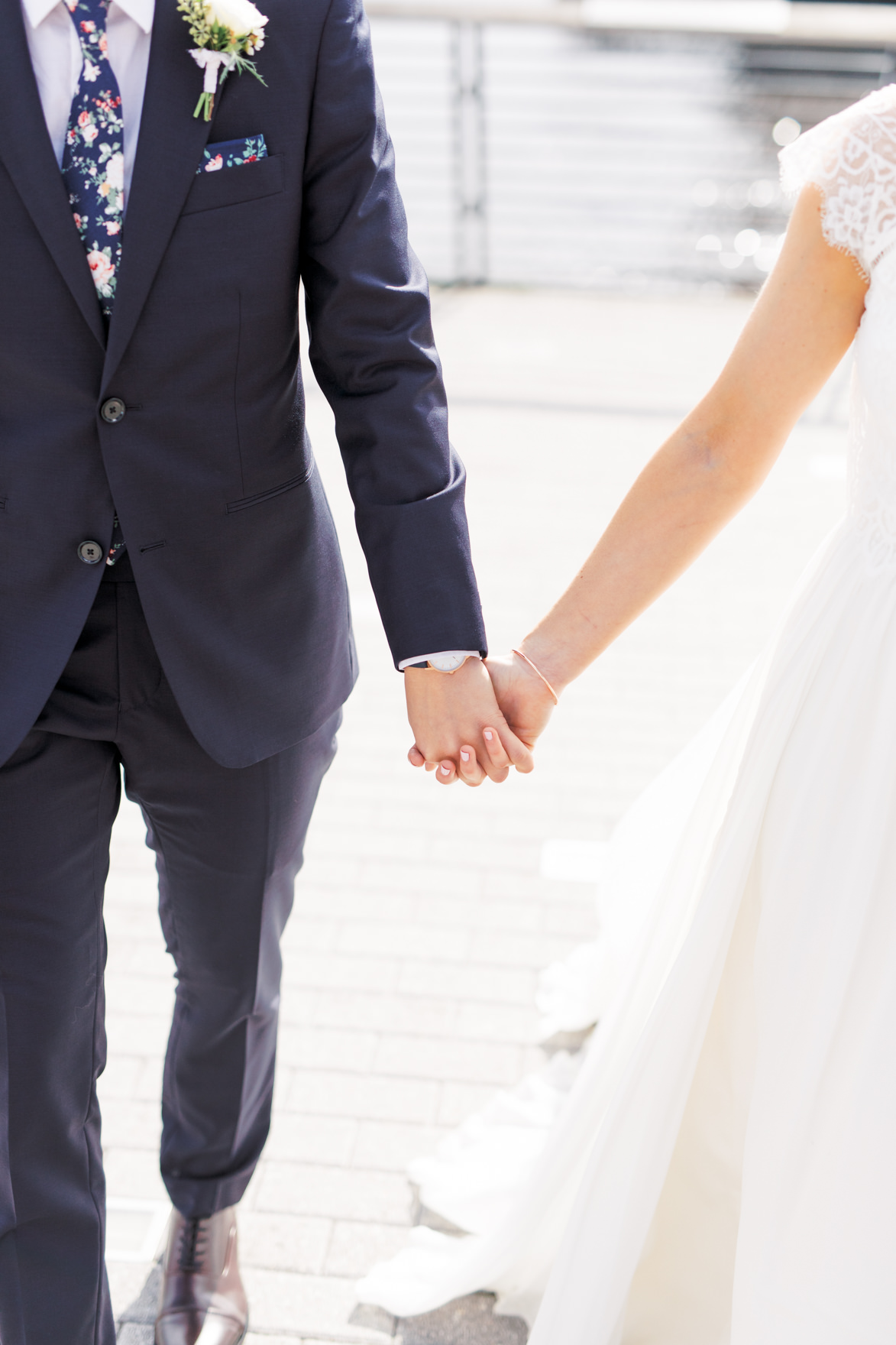 Walking hand in hand in the sunshine as they are about to head into their modern and elegant old city Philadelphia wedding at Power Plant Productions. Power Plant Production wedding photographer