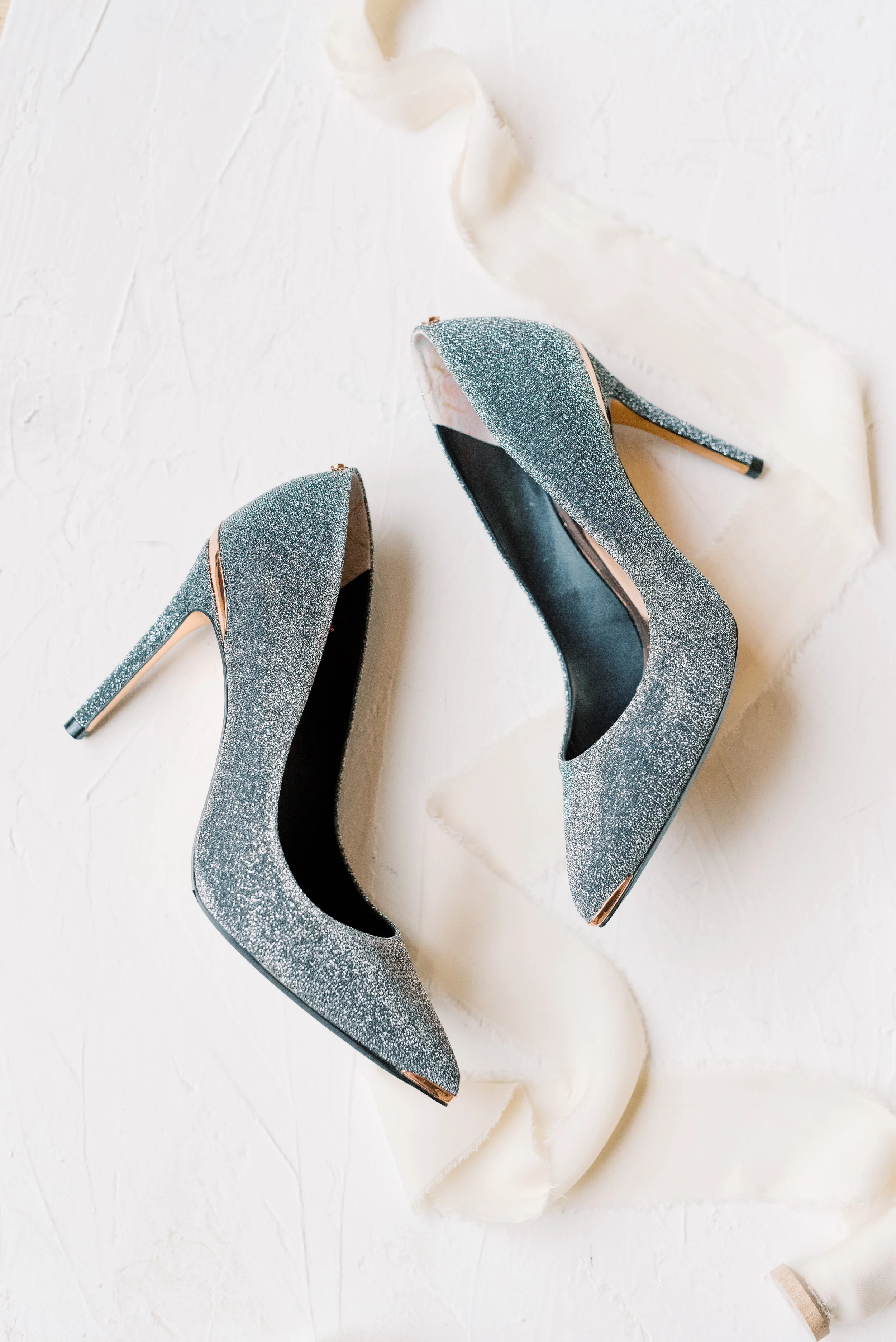 We always love when our brides add a little something sparkly, like these glitzy silver heels from this romantic and classic wedding day for their french inspired green and white Cairnwood Estate wedding