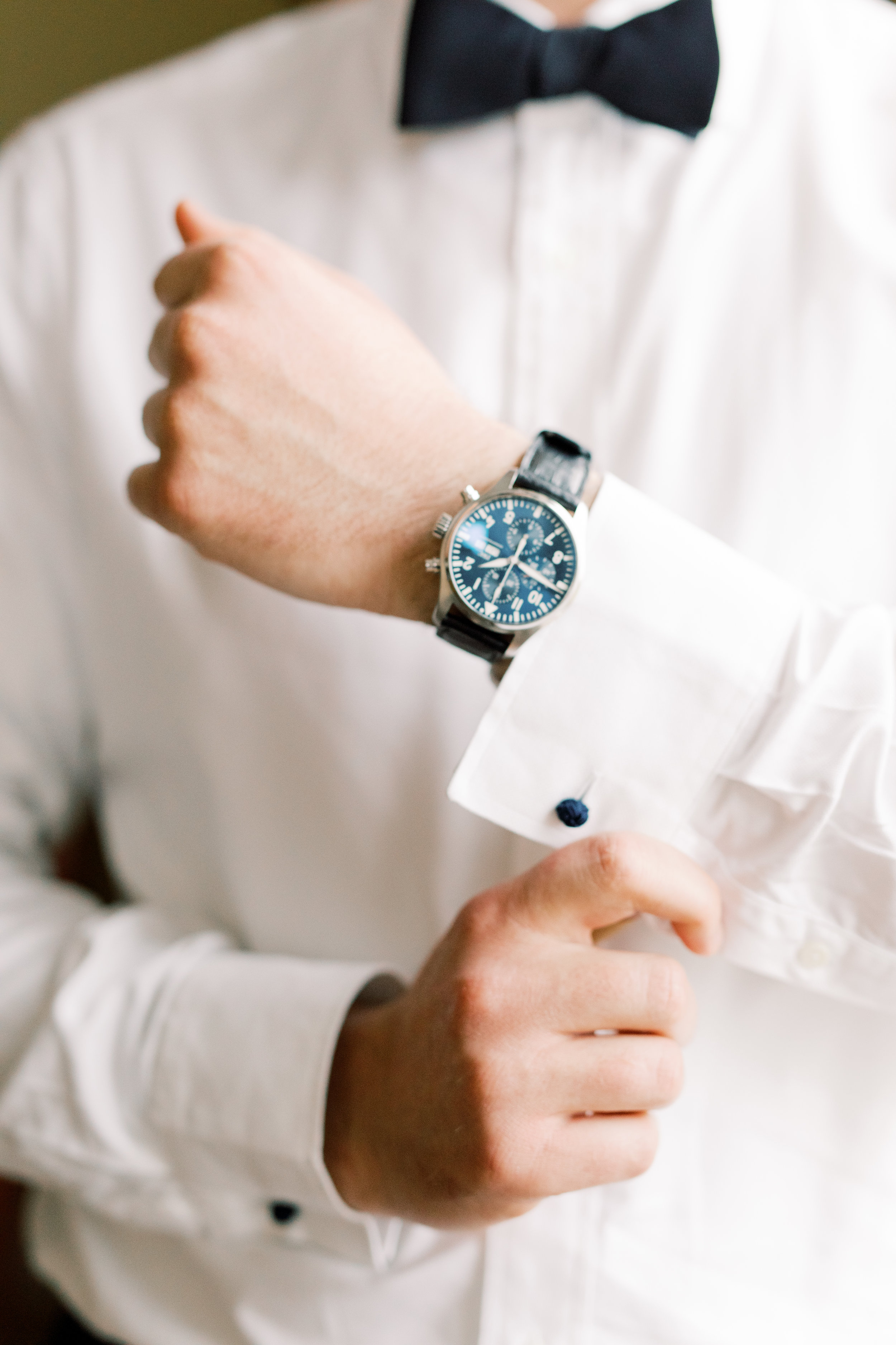 A clssy timepiece is always welcome on our grooms, like this blue watch from this romantic and classic wedding day for their french inspired green and white Cairnwood Estate wedding