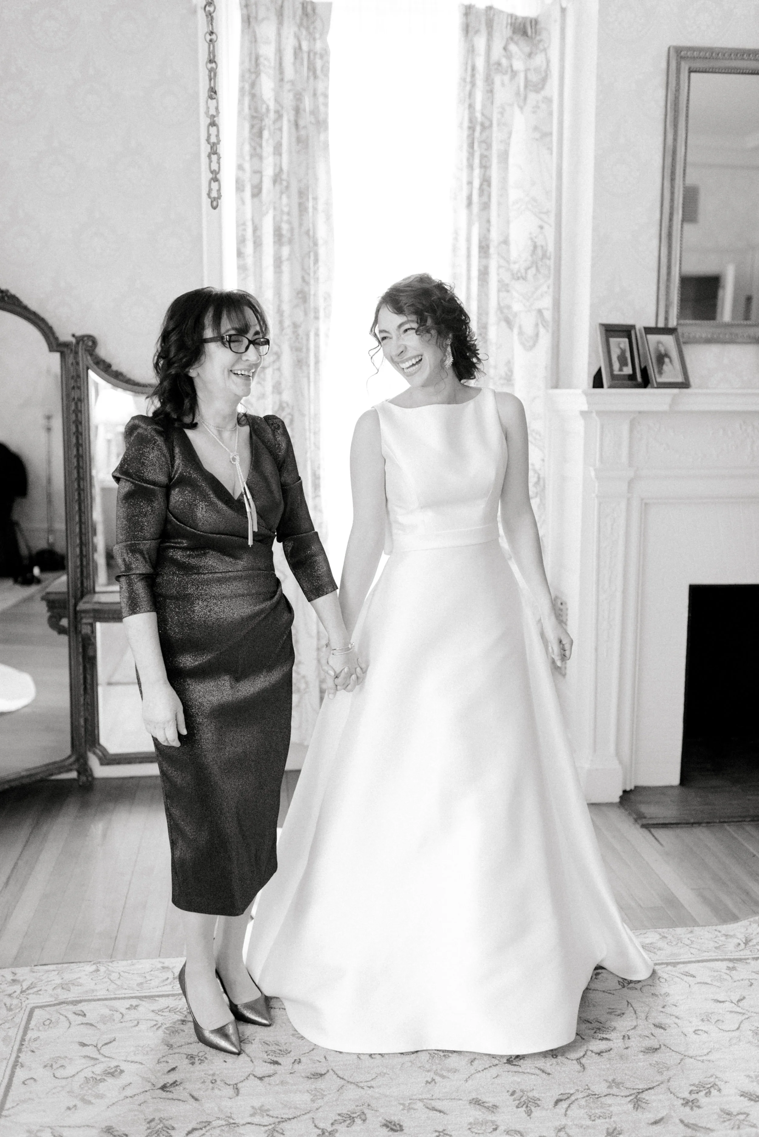 Our lovely bride shares a laugh with her mother, just moments before her romantic and classic wedding day for their french inspired green and white Cairnwood Estate wedding