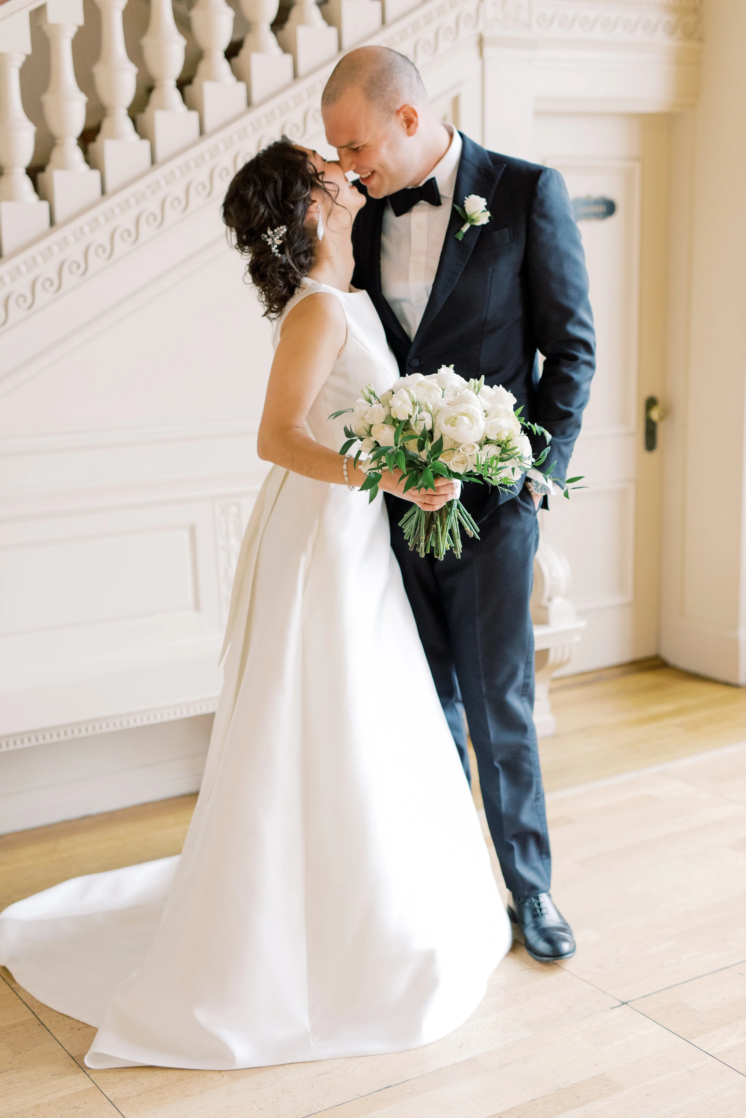 A sweet moment as our classic bride and groom share a kiss just moments before their romantic and classic wedding day for their french inspired green and white Cairnwood Estate wedding