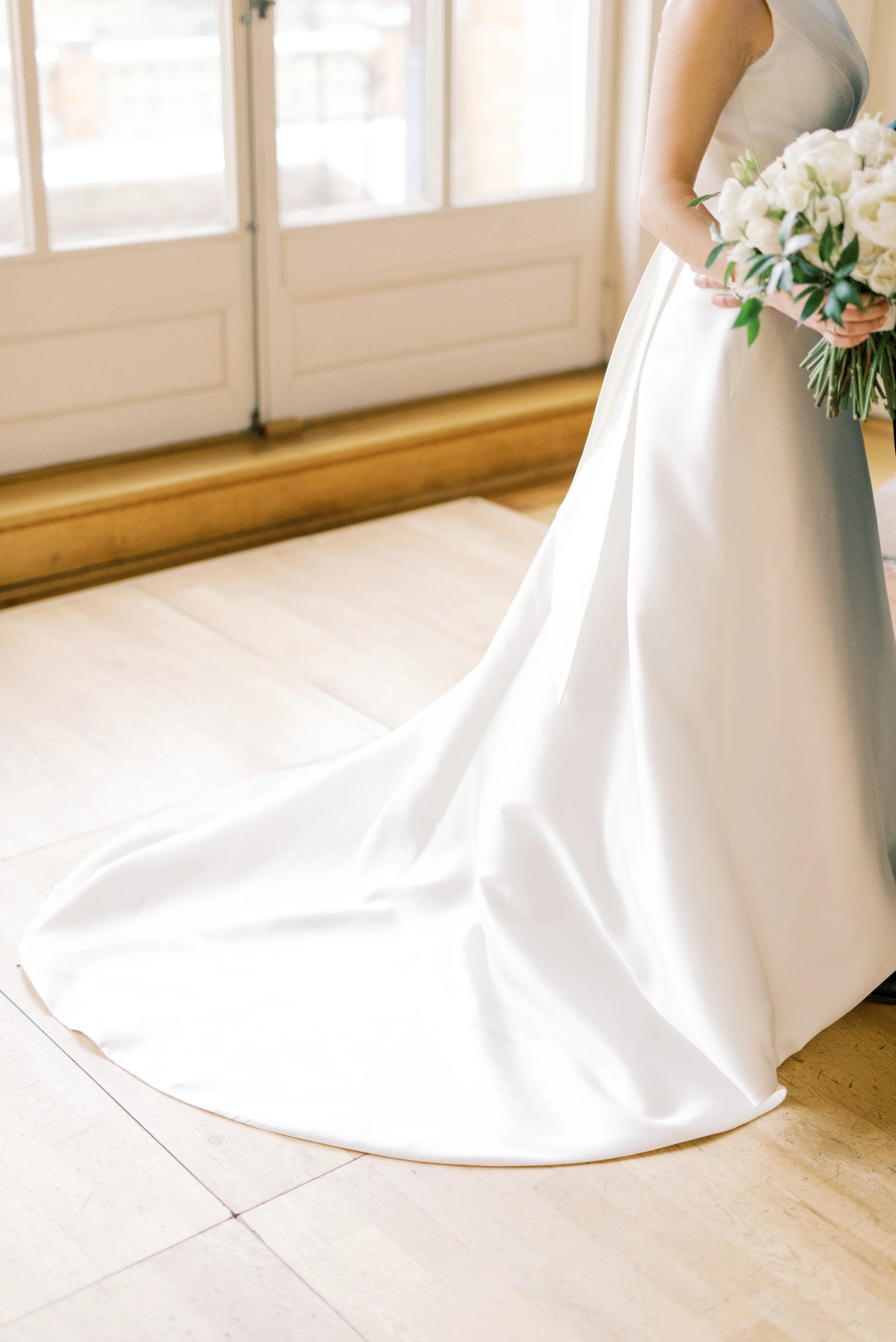 The mini train on this modern structured a-line dress was the perfect touch to let you know that it’s a wedding gown from this romantic and classic wedding day for their french inspired green and white Cairnwood Estate wedding