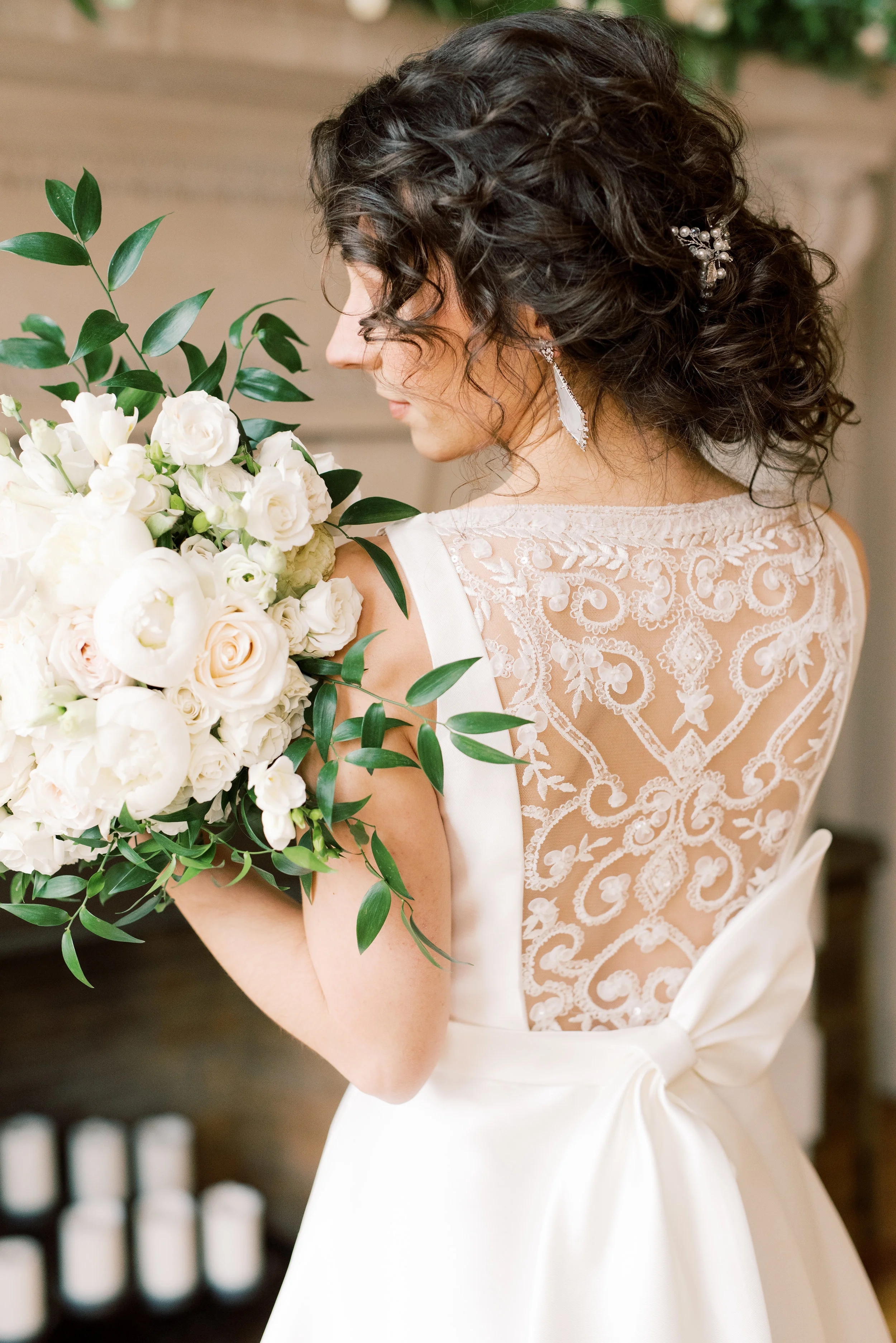 This bride’s soft curls and the trailing greens of her bouquet add a romantic touch to this romantic and classic wedding day for their french inspired green and white Cairnwood Estate wedding