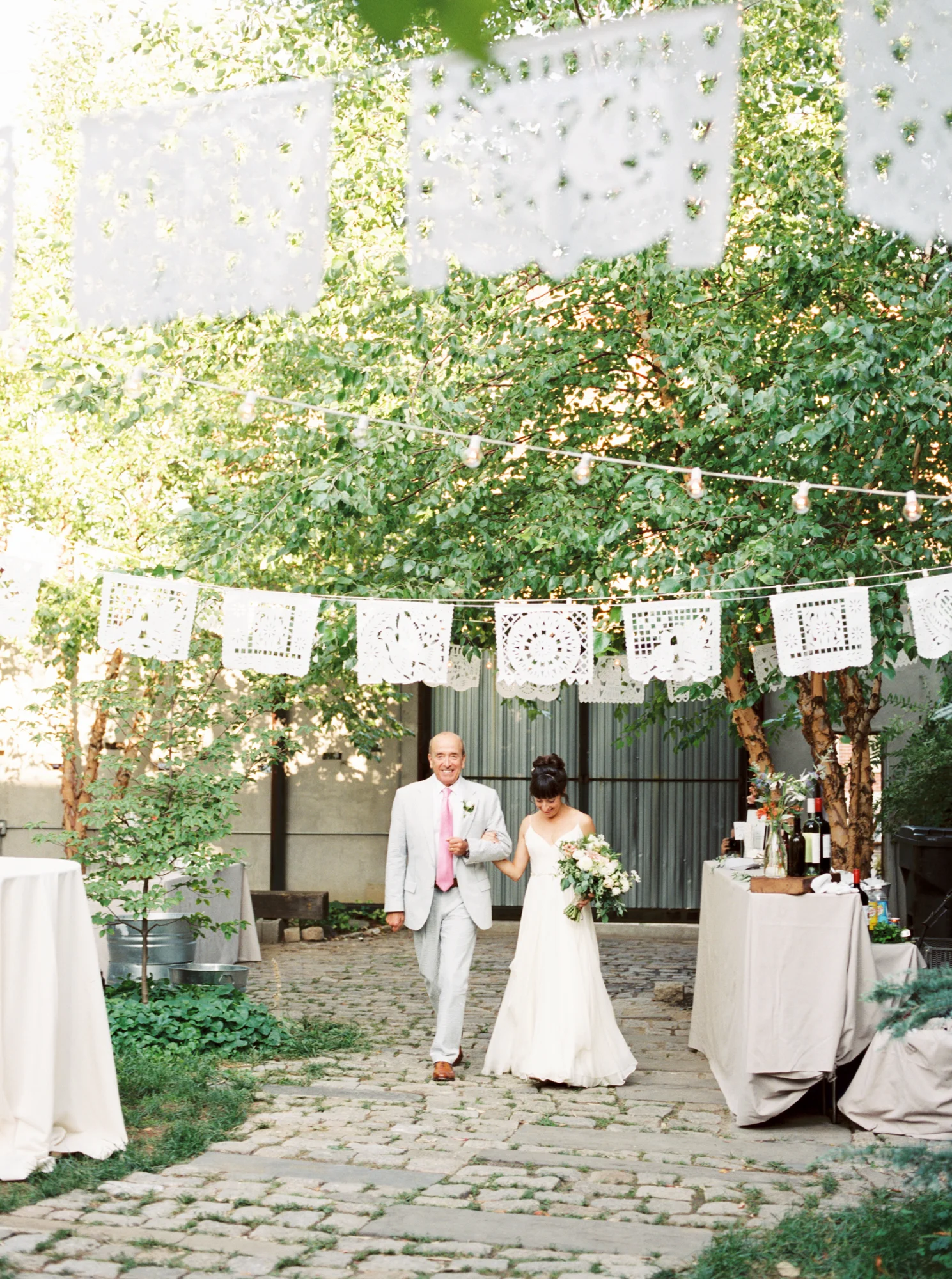 Stone walkways, a canopy of trees, and trailing vines, all in this little unsuspecting block in Philadelphia. We love this little oasis in the city for a modern couple wanting to get married in a cool space. Maas Building wedding photographer.