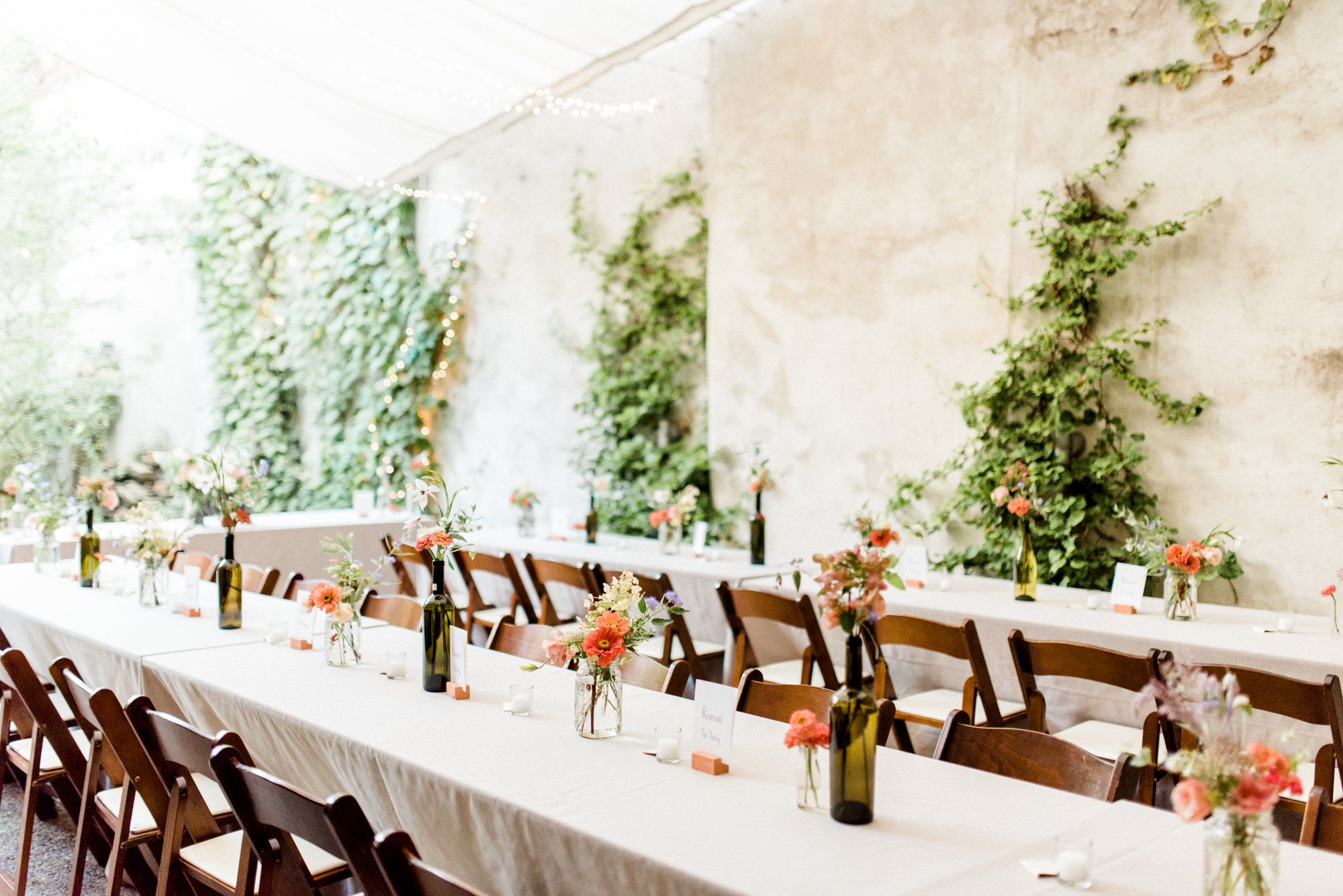 Quant and modern with a magical garden vibe are all the feels with these vine covered walls and cute farm tables. We love this little oasis in the city for a modern couple wanting to get married in a cool space. Maas Building wedding photographer.