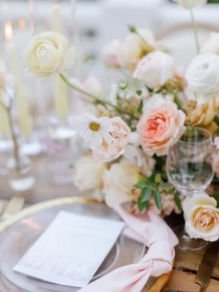 beautiful wedding table display with pastel florals and wine glass