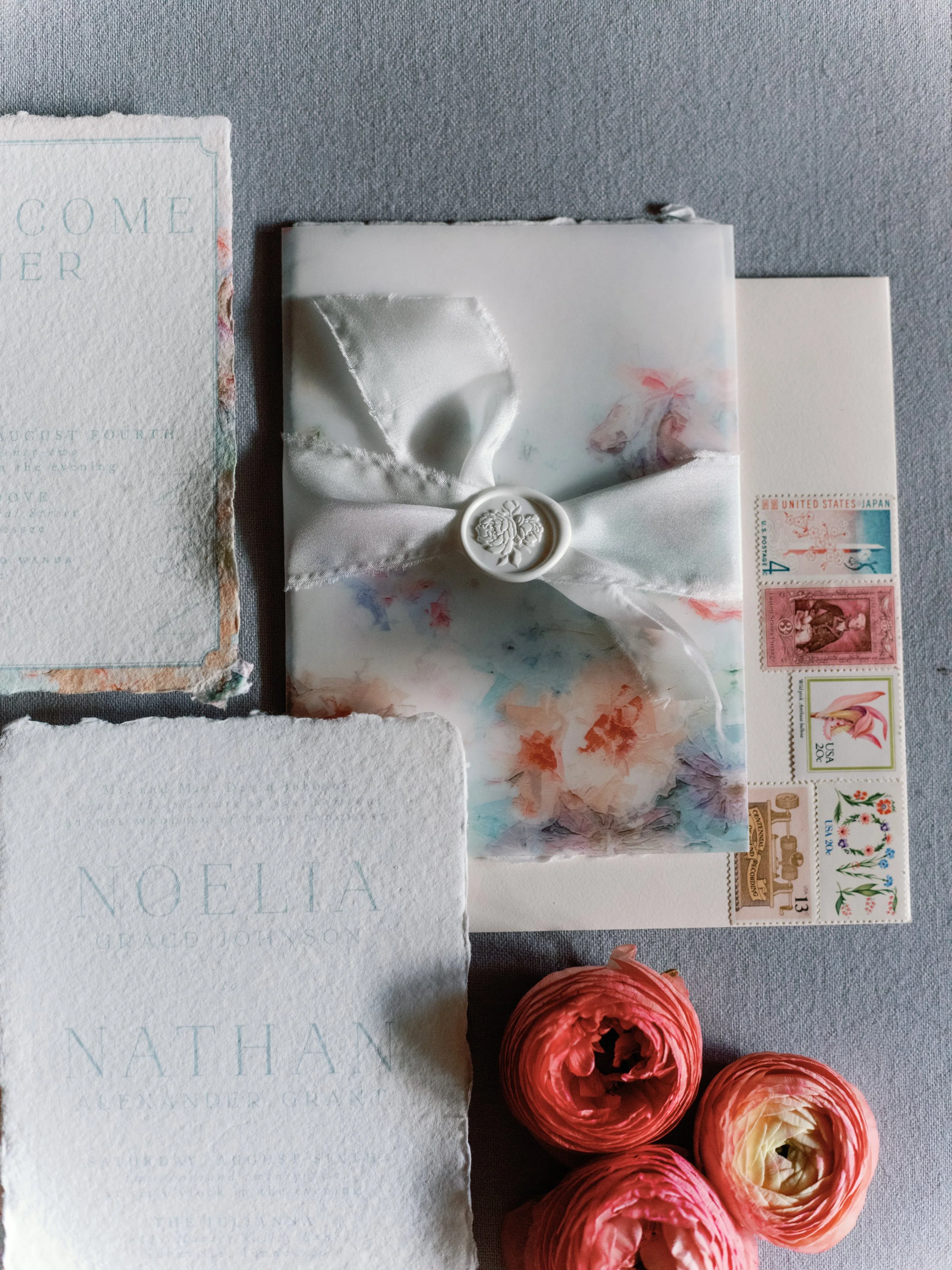 light blue and grey stationery with pastel blues and pinks with soft ribbons