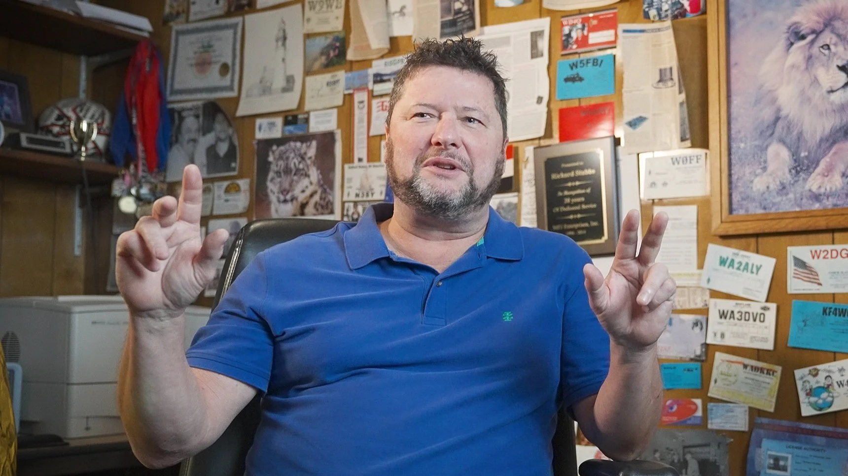 Richard Stubbs Sales Director of MFJ in his office surrounded by HAM Radio Cards
