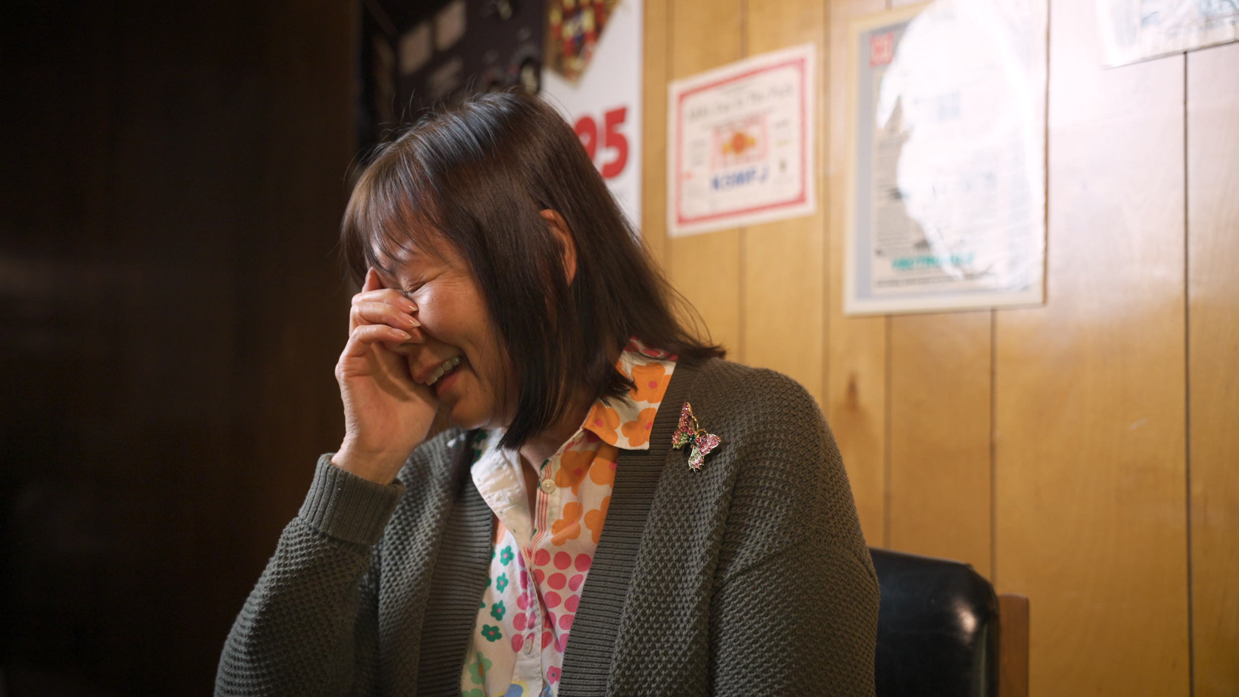 Betty Jue (wife of Martin Jue) laughs and covers her face while thinking of their daughter Deanna as a child