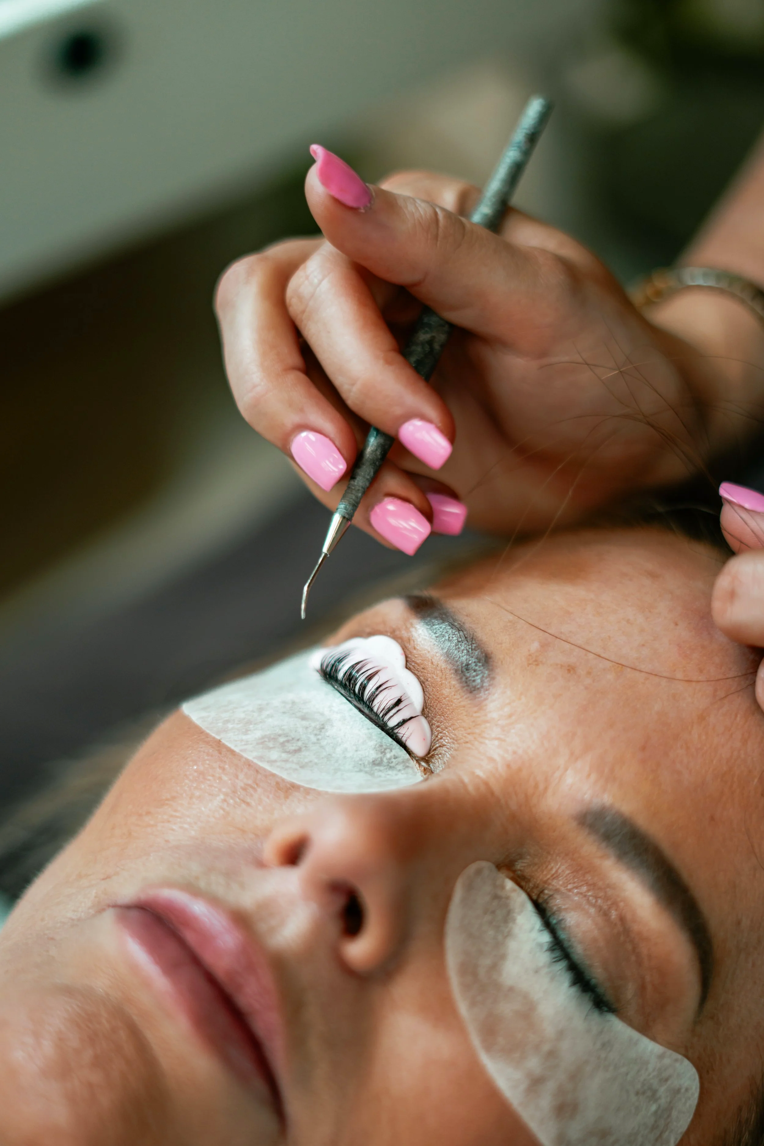 woman getting a lash lift and brow services at raw beauty salon and spa in fort smith arkansas
