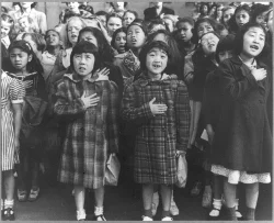 Dorothea Lange photograph of Japanese-American children reciting the pledge of allegiance.