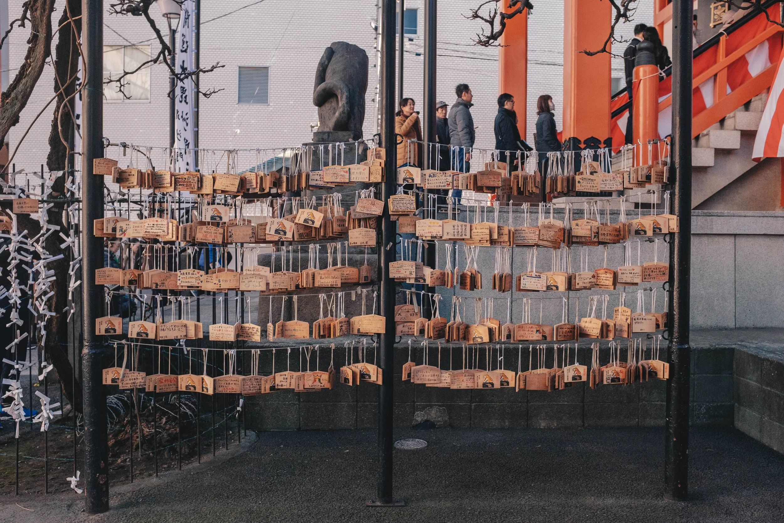 It is customary to write one's wishes onto Ema tablets and then hang them onto racks whilst visiting shrines in Japan