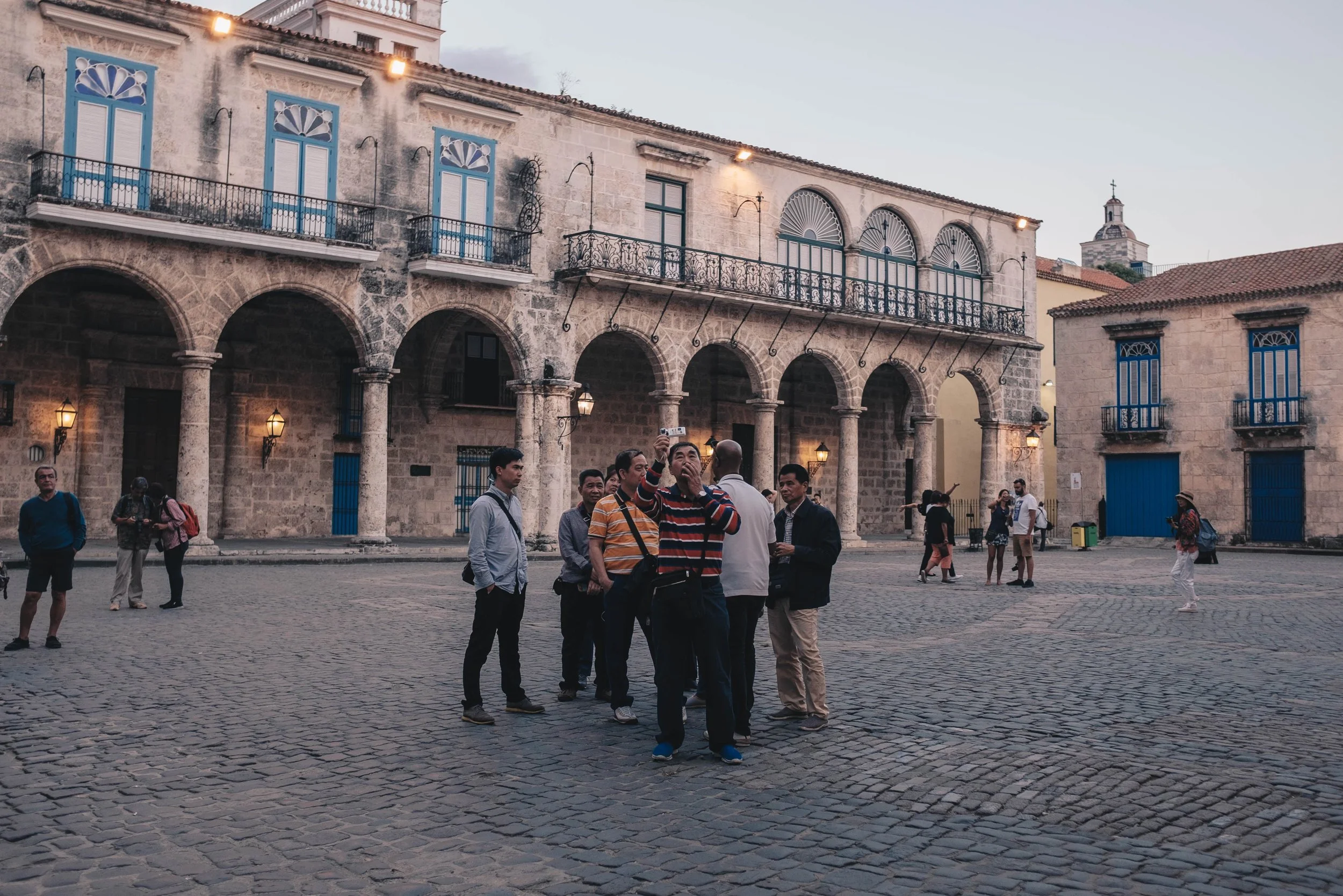 Chinese tourists exploring and documenting La Habana Vieja through their own lens
