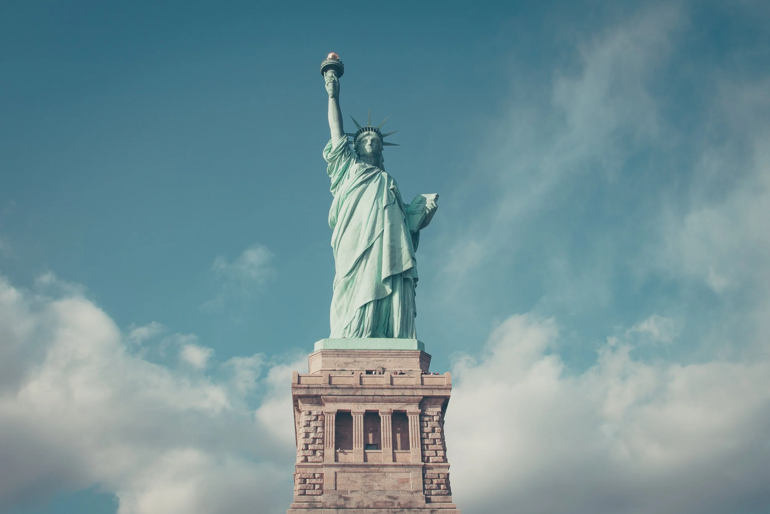 The Statue of Liberty stands proud as a veritable symbol of New York City, photo by Anthony DELANOIX on Unsplash