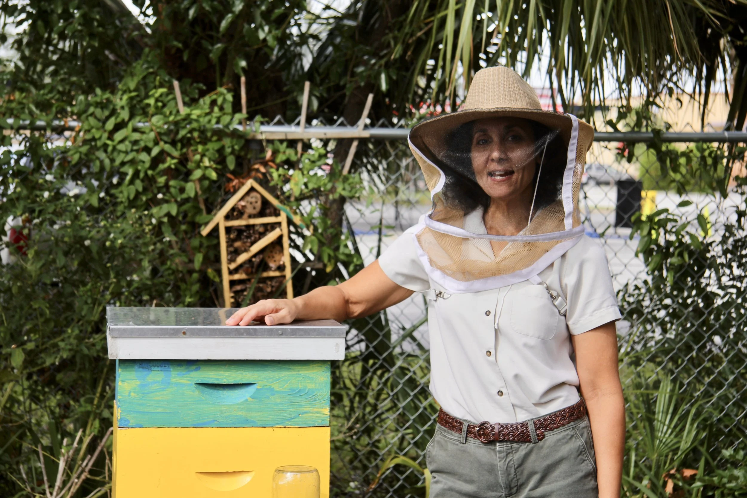 Marilyn Young, Jacksonville beekeeper, stands next to one of her hives. 