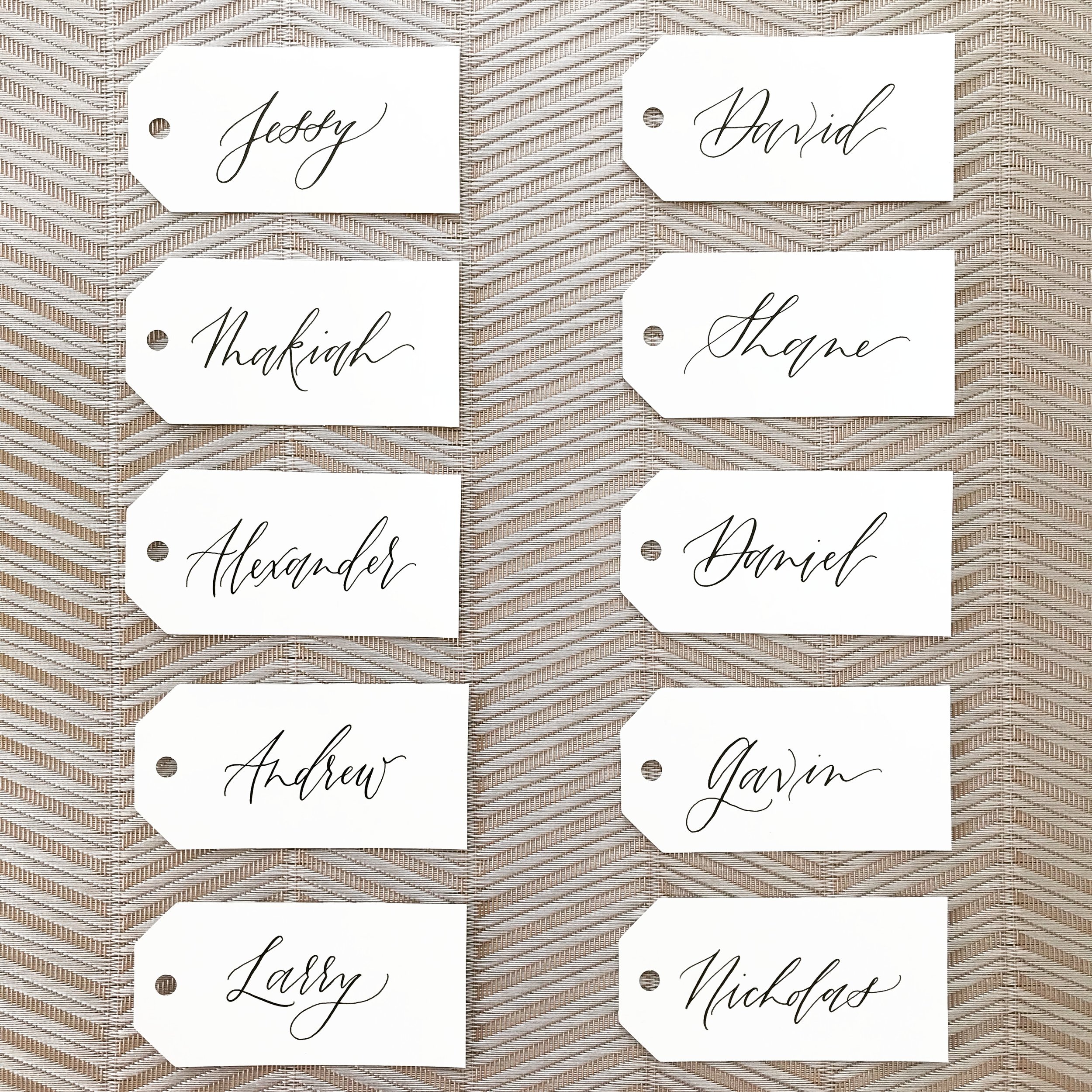 Wedding Place Cards of white tags with black ink calligraphy