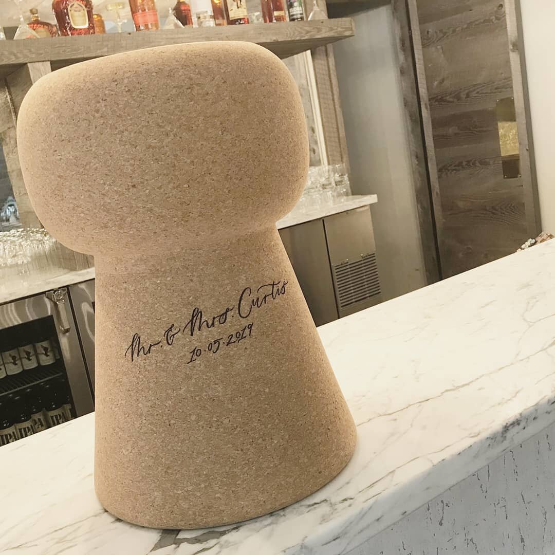 Pop the champagne!🍾
.
When Melanie and Aaron asked me to write on a giant cork for their guest book, of course I said yaaass! Such a unique idea and for those of you wondering *hello calligraphy friends* cork was WAY easier to write on then I expect