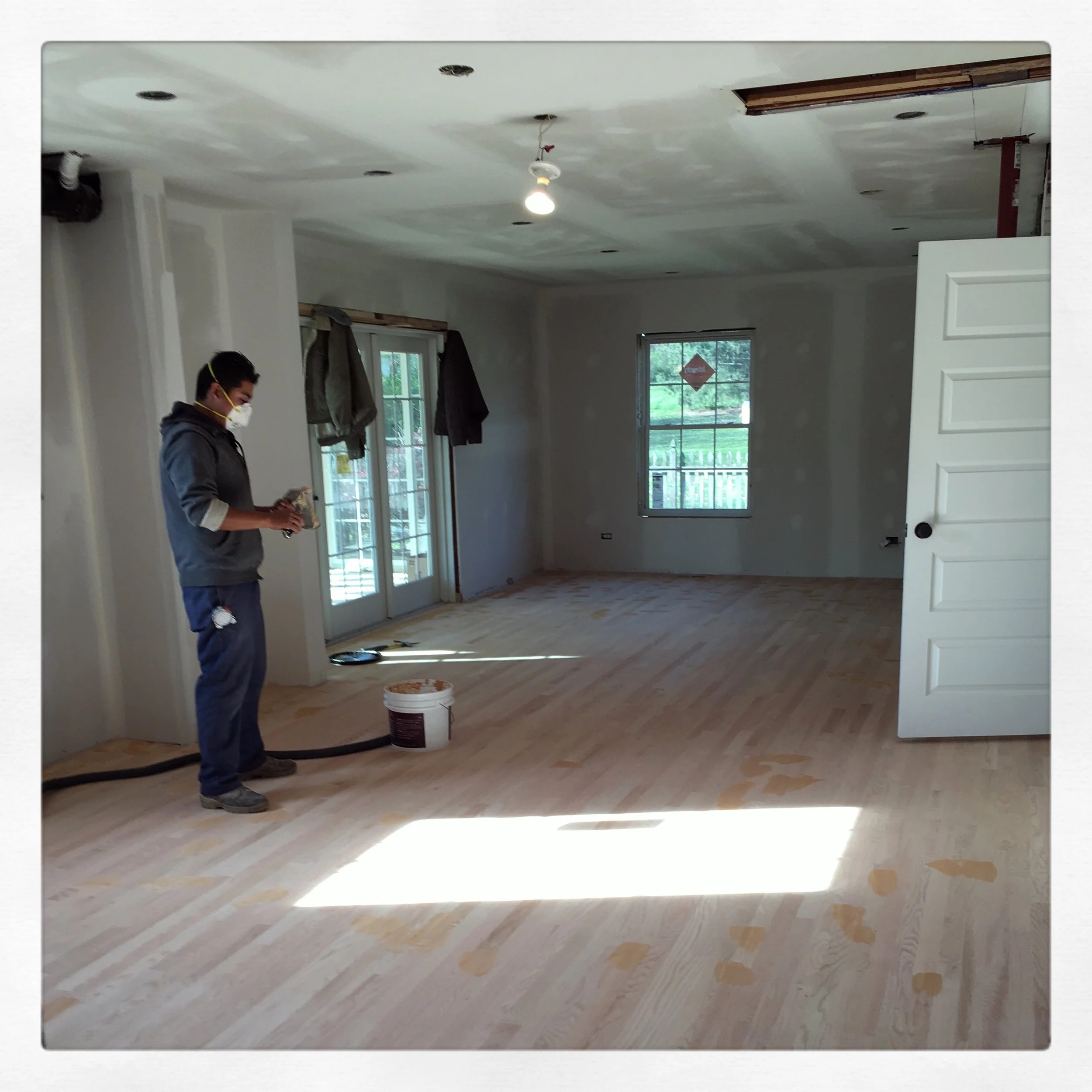 Just in the nick of time, that structural doorway was removed to make way for new hardwoods throughout the back two rooms. Our kitchen had hardwoods when we moved in, although they were installed on a few layers of tile, so we removed them, patched in a good portion of sub flooring and installed all new hardwoods at the same level as the mudroom and foyer tile. 